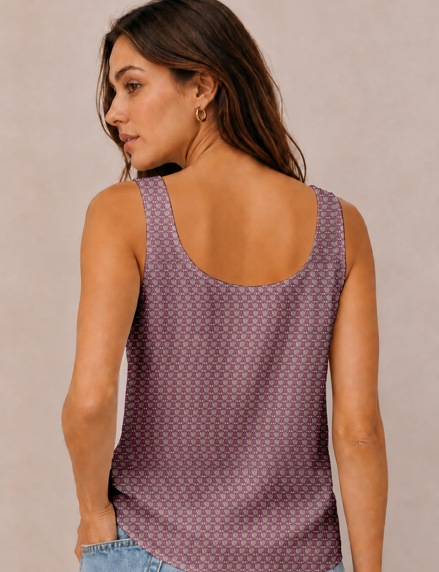 Women's sleeveless blouse with a relaxed straight fit, wide scoop neckline, deep scoop back, and hip-length silhouette.