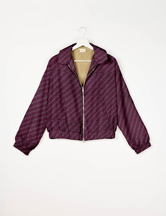 Upcycled Bomber Jacket made from recycled sari materials, featuring a cute cropped shape, elasticated hem and cuffs, and contrast sari print lining. Sustainable apparel promoting eco-friendly fashion and ethical clothing.