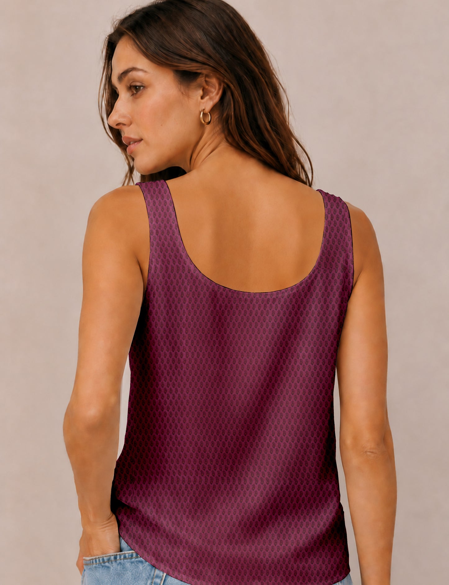 Women's sleeveless blouse with a relaxed straight fit, wide scoop neckline, deep scoop back, and hip-length silhouette.