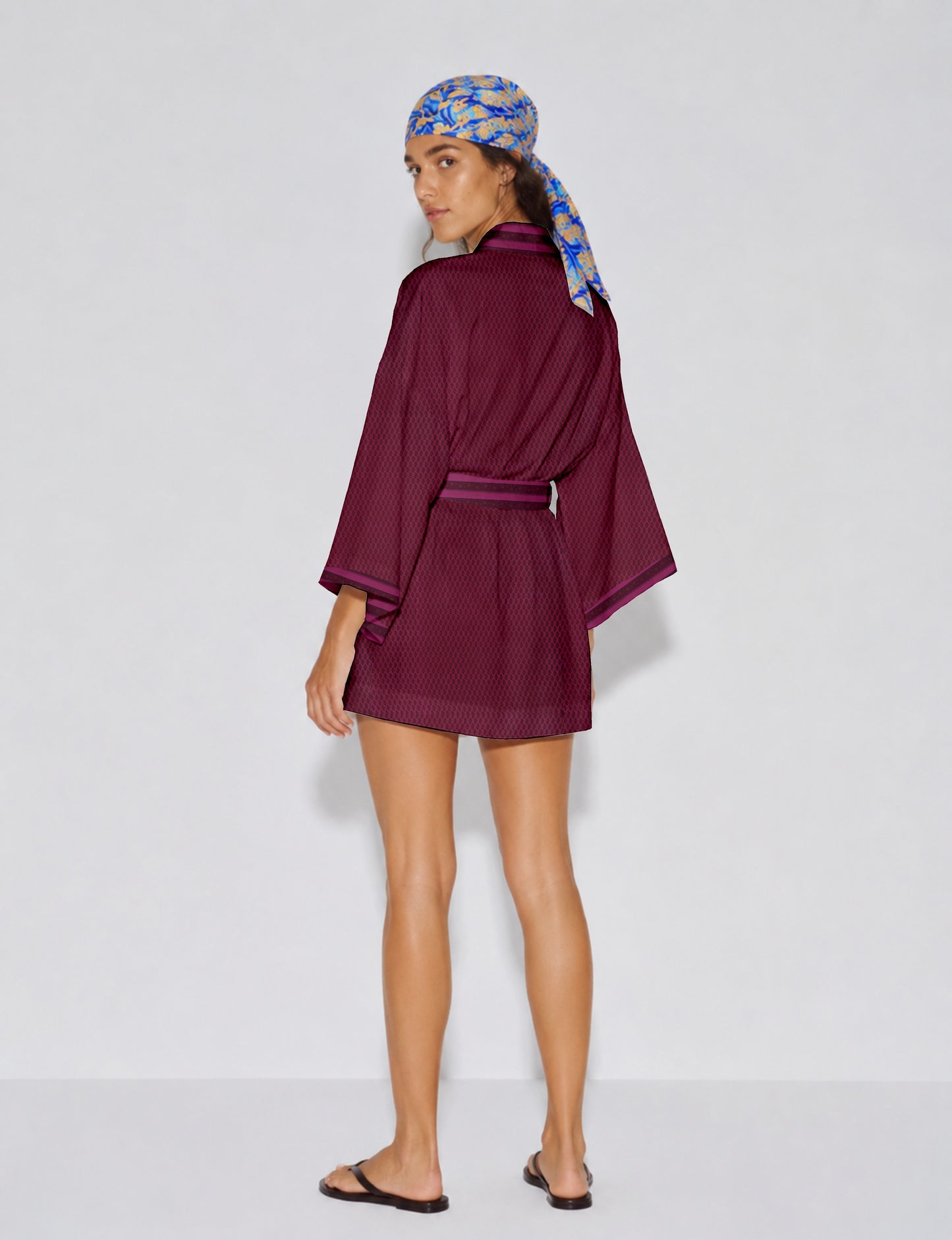 Short kimono robe with wrap front, V-neckline, wide sleeves, waist tie, and concealed skort detail.