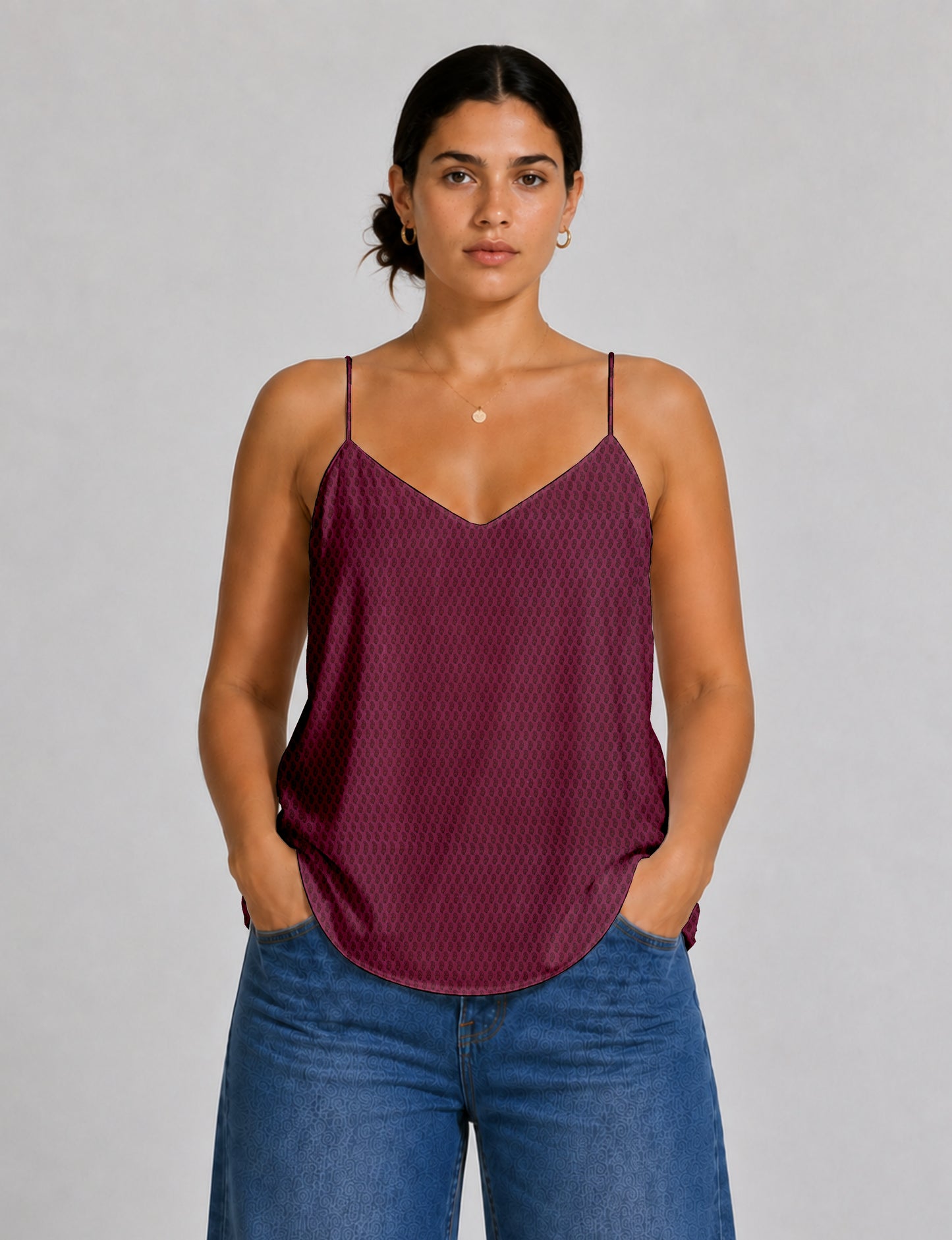 Women's sleeveless slip top with a relaxed straight fit, soft V-neckline, deep V-back, and delicate spaghetti straps.