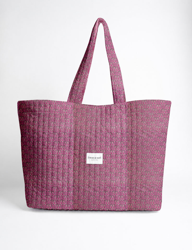 Quilted yellow tropical patterned beach bag with long handles and white label reading "I was a sari" front view