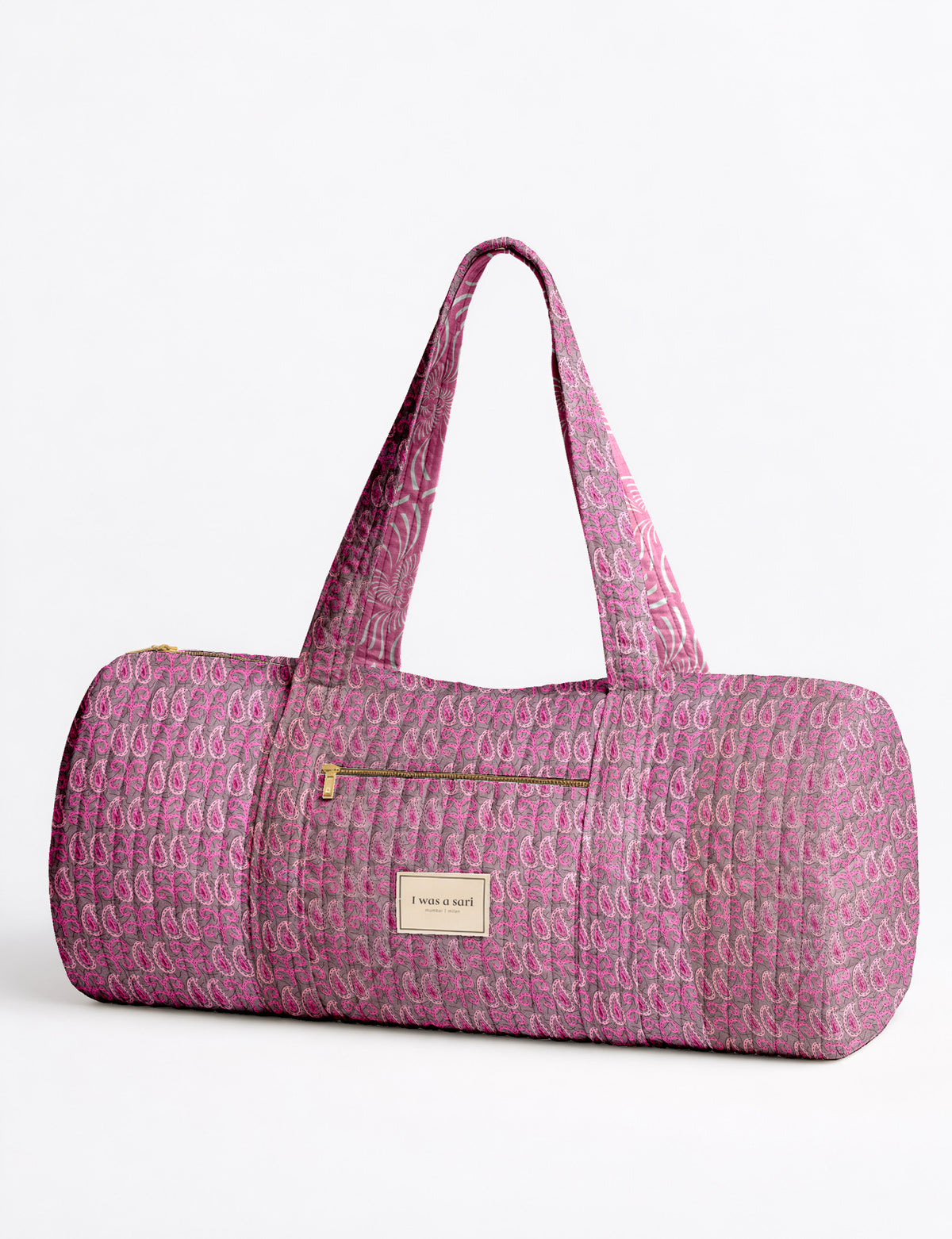 Brown paisley quilted bowling bag with dual handles, front zipper pocket, and "I was a sari" label on front side