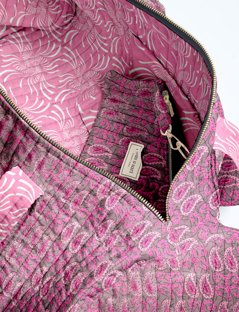 Brown paisley quilted bowling bag with dual handles, front zipper pocket, and "I was a sari" label on front side