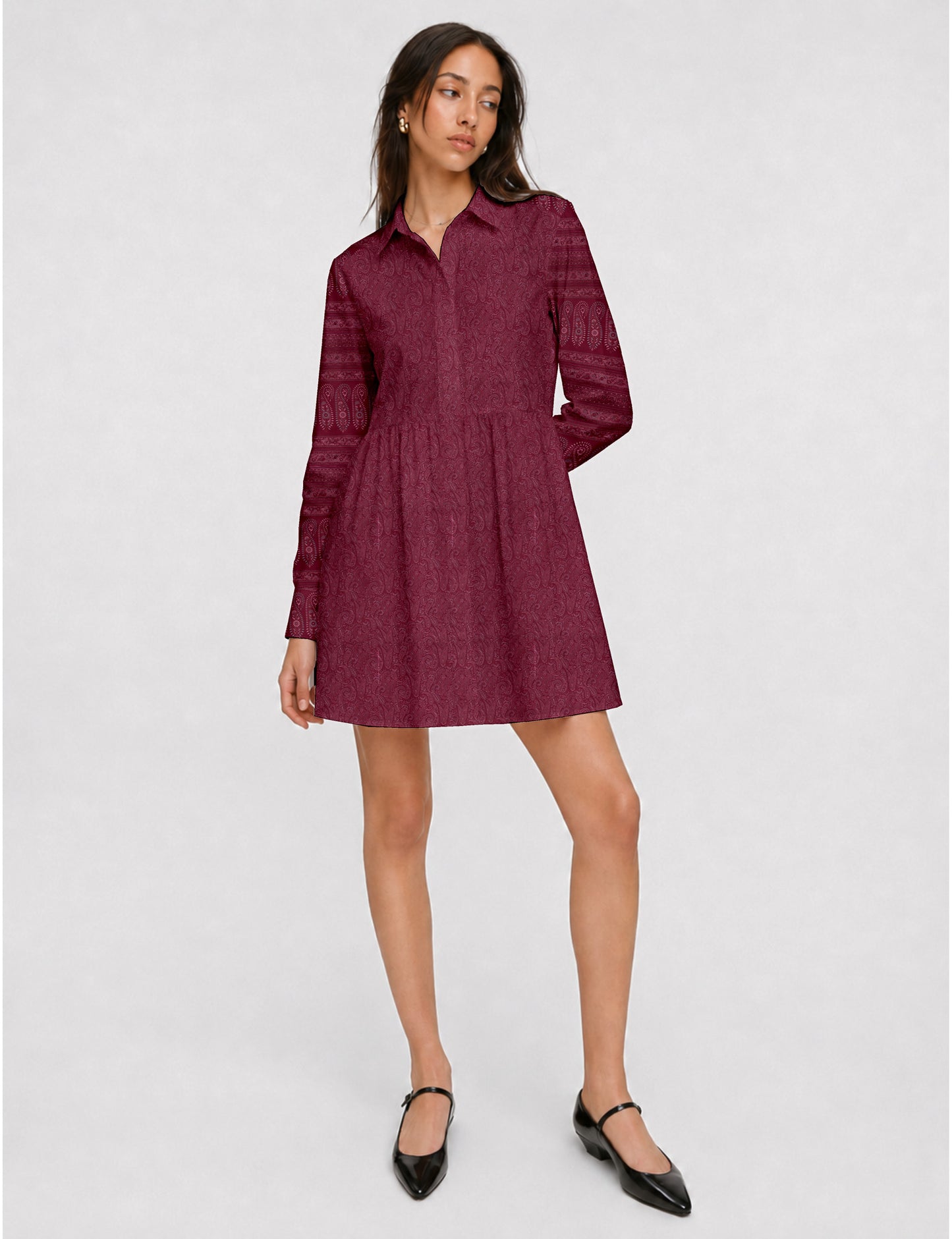 Short shirt dress with a relaxed A-line silhouette, point collar, partial button placket, gathered waist, side pockets, and full-length cuffed sleeves.