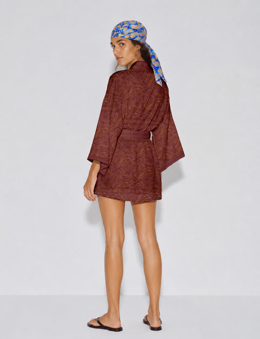 Short kimono robe with wrap front, V-neckline, wide sleeves, waist tie, and concealed skort detail.