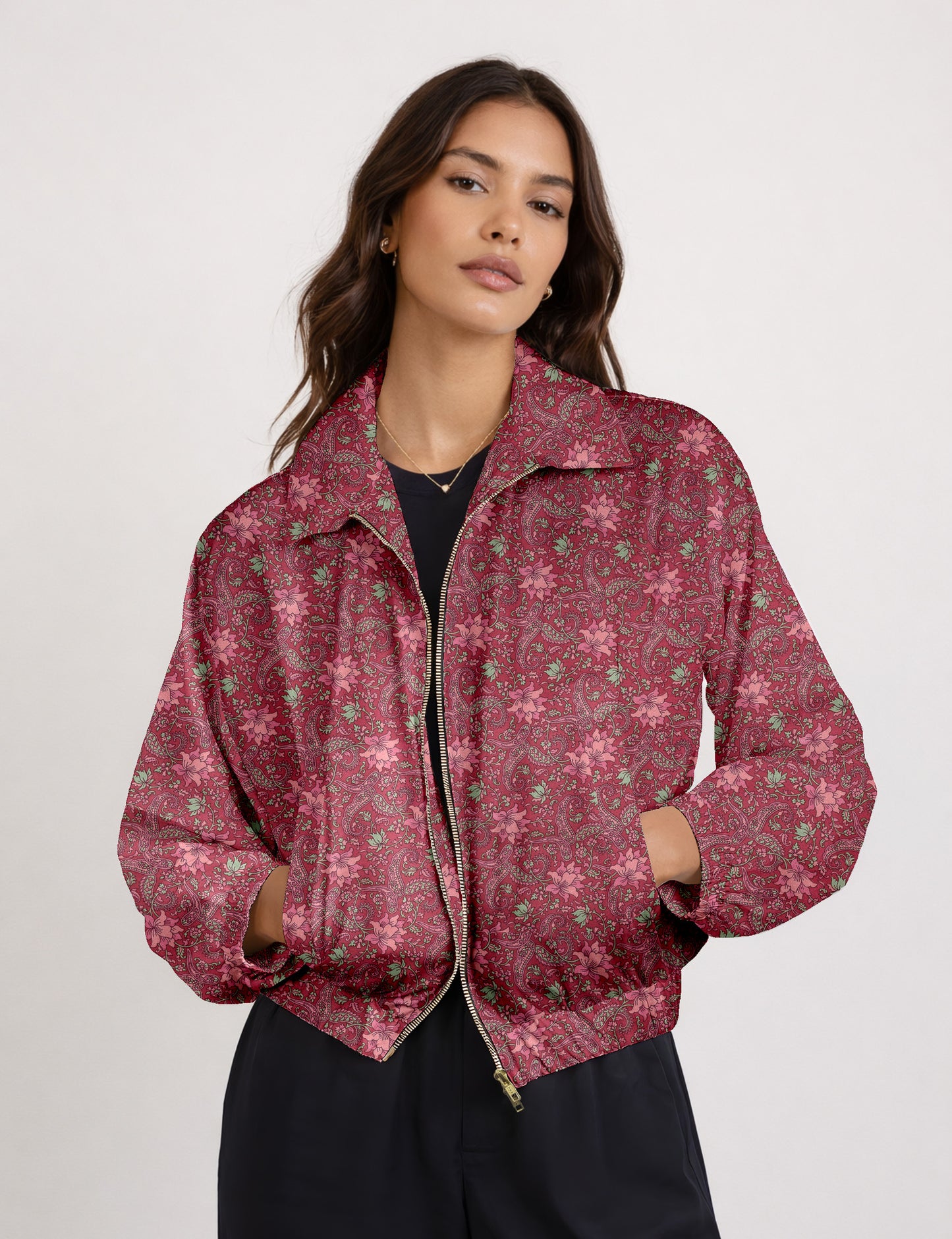 Women's cropped bomber jacket with twin metallic front zippers, welt pockets, elasticated hem and cuffs, and contrast sari print lining.