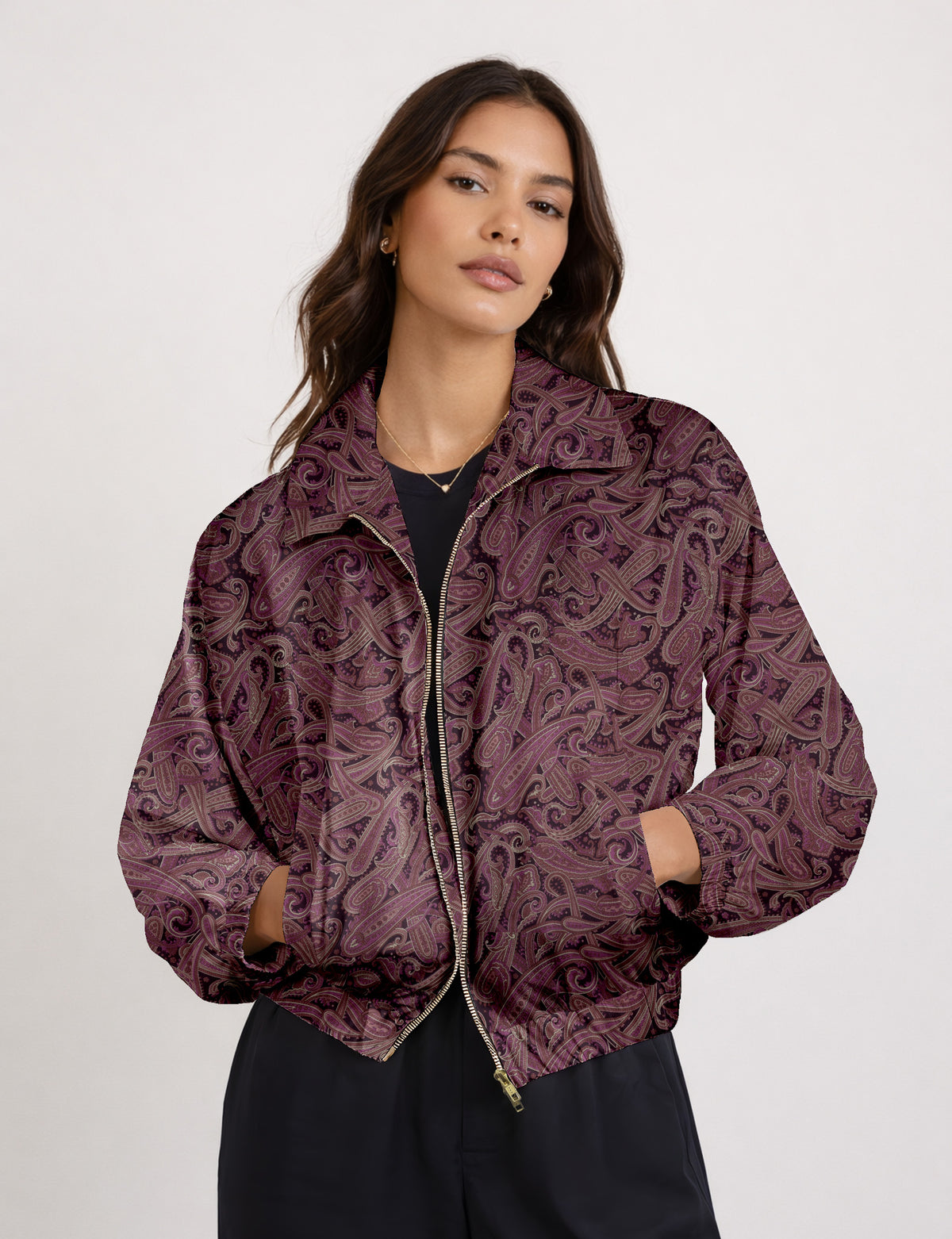 Woman wearing a yellow floral bomber jacket with front zipper, elastic cuffs, and side pockets, shown from front view