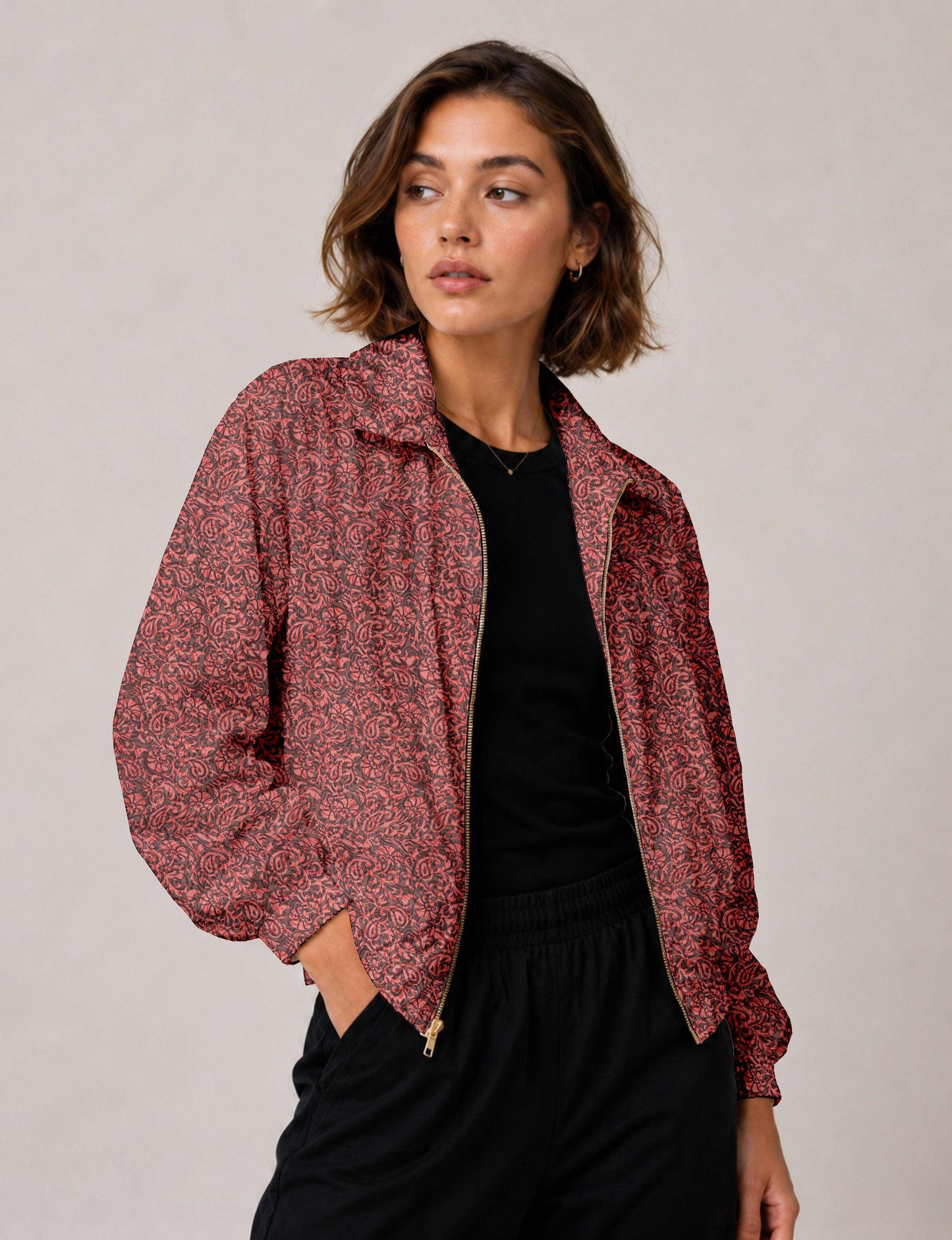 Woman wearing a yellow floral bomber jacket with front zipper, elastic cuffs, and side pockets, shown from front view