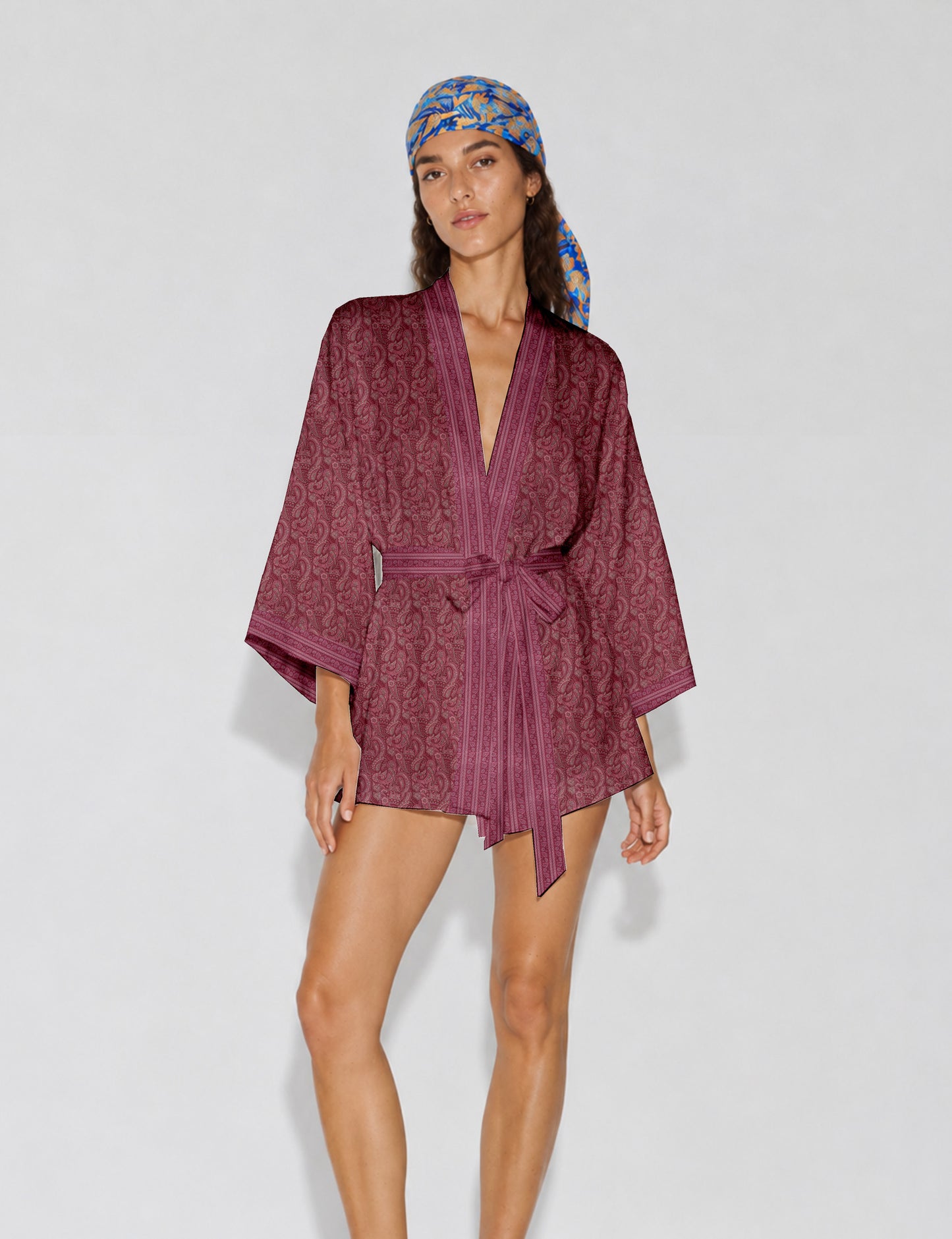 Short kimono robe with wrap front, V-neckline, wide sleeves, waist tie, and concealed skort detail.