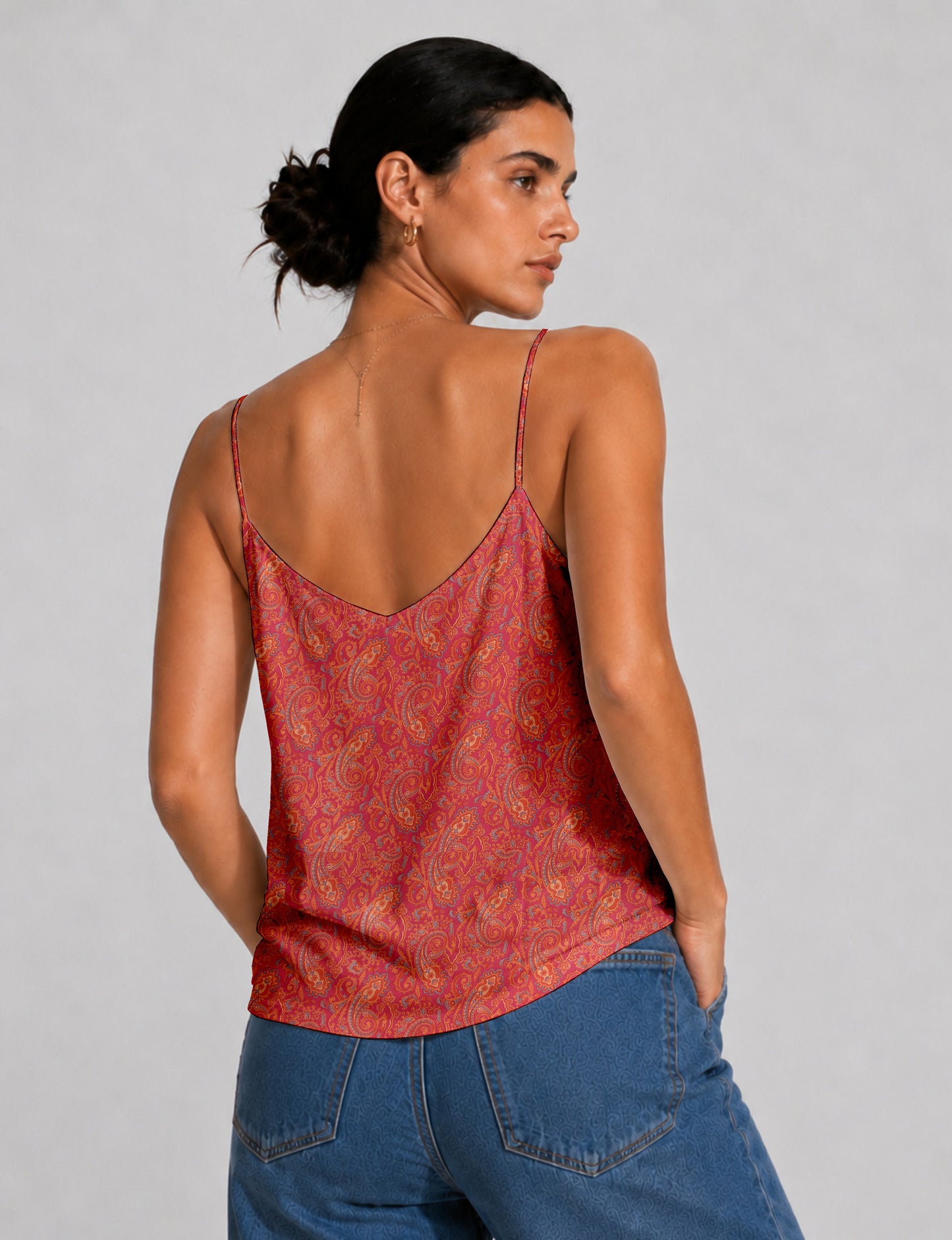 Women's sleeveless slip top with a relaxed straight fit, soft V-neckline, deep V-back, and delicate spaghetti straps.