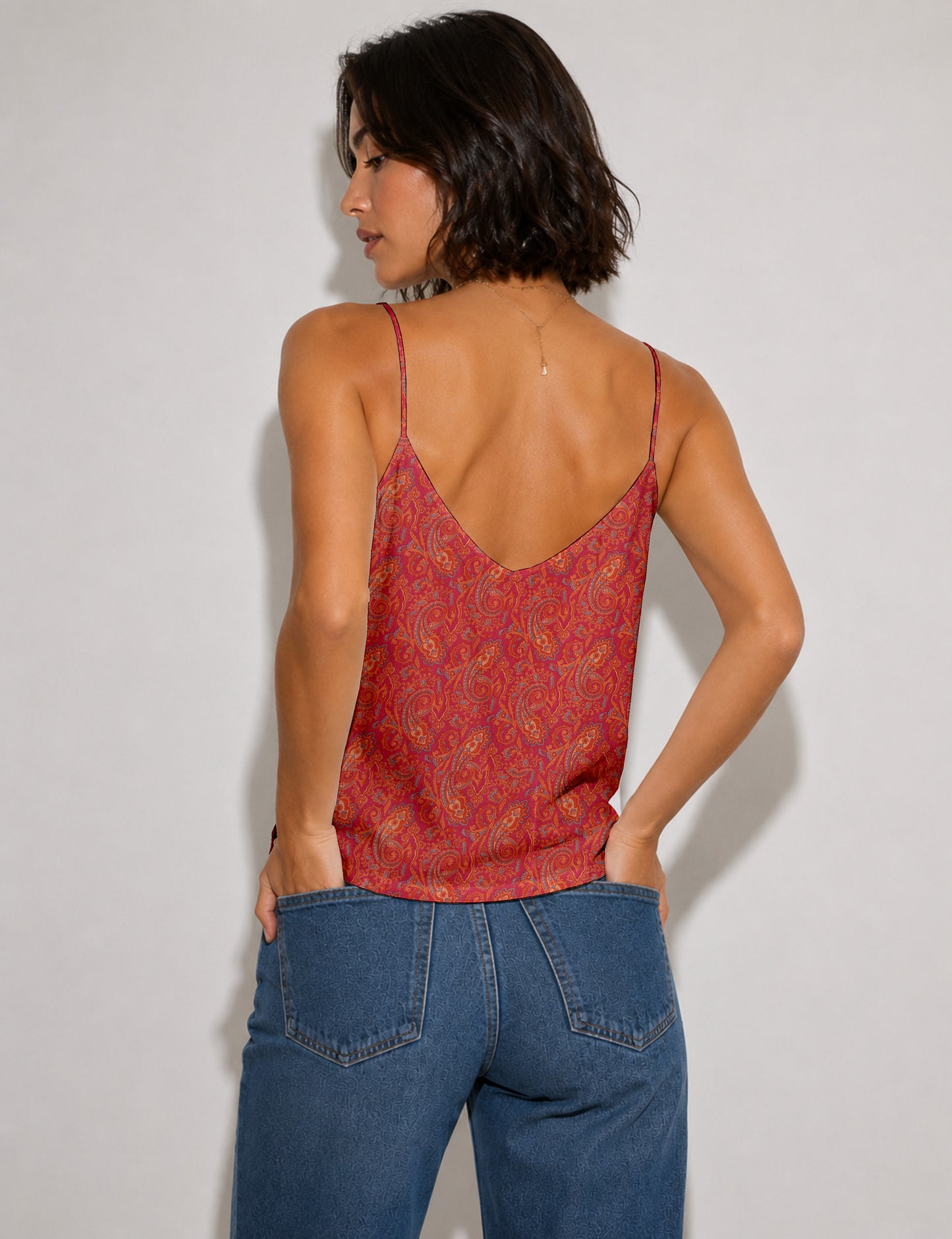 Women's sleeveless slip top with a relaxed straight fit, soft V-neckline, deep V-back, and delicate spaghetti straps.