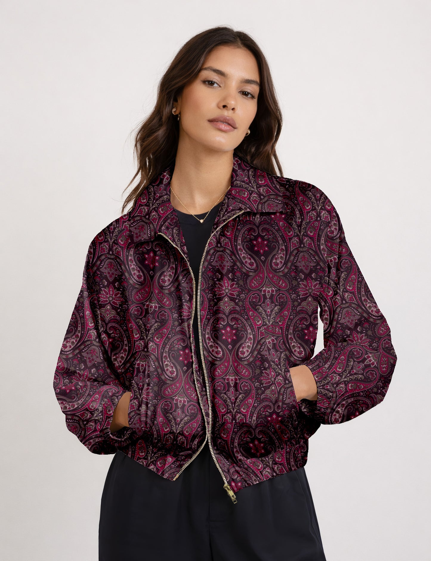 Woman wearing a yellow floral bomber jacket with front zipper, elastic cuffs, and side pockets, shown from front view