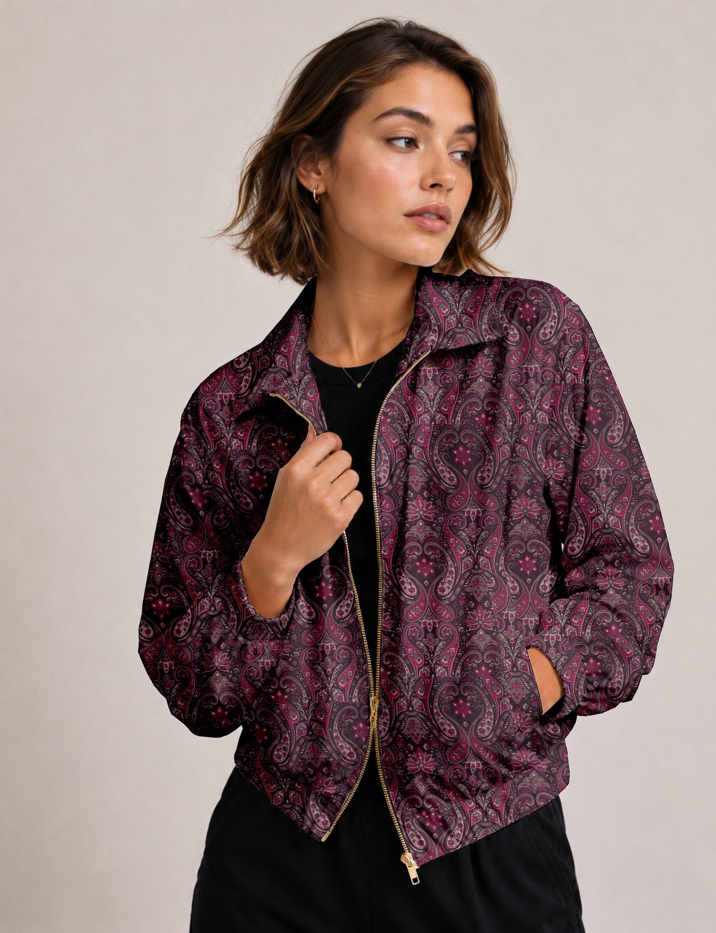 Woman wearing a yellow floral bomber jacket with front zipper, elastic cuffs, and side pockets, shown from front view