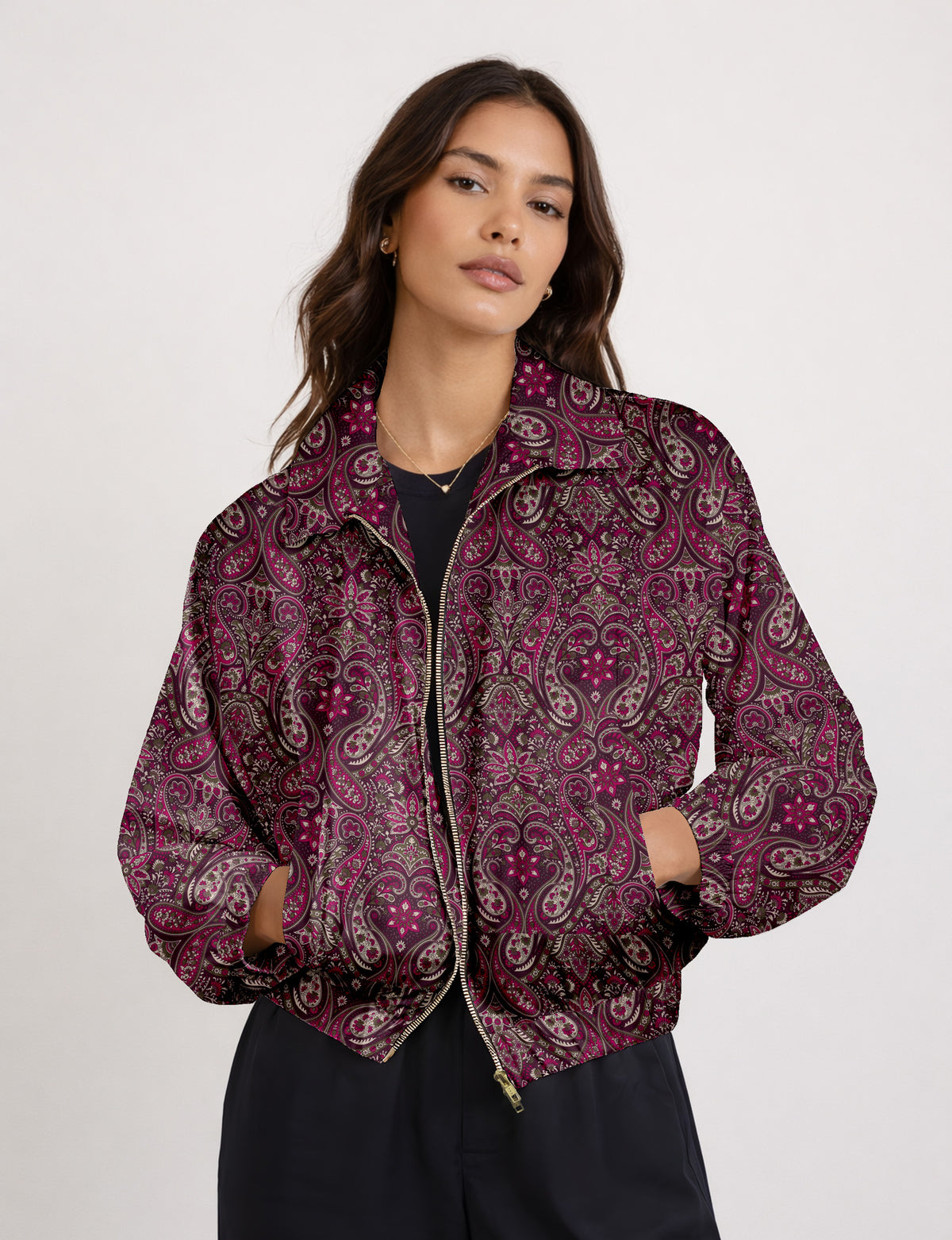 Woman wearing a yellow floral bomber jacket with front zipper, elastic cuffs, and side pockets, shown from front view