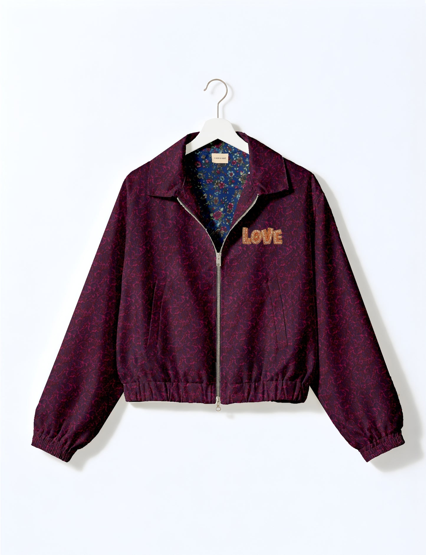 Love Bomber Jacket made from recycled fabric, featuring hand-stitched Aari embroidery. A unique piece of zero-waste clothing, part of the circular fashion movement. Designed with upcycled materials for a stylish yet environmentally friendly clothing choice.