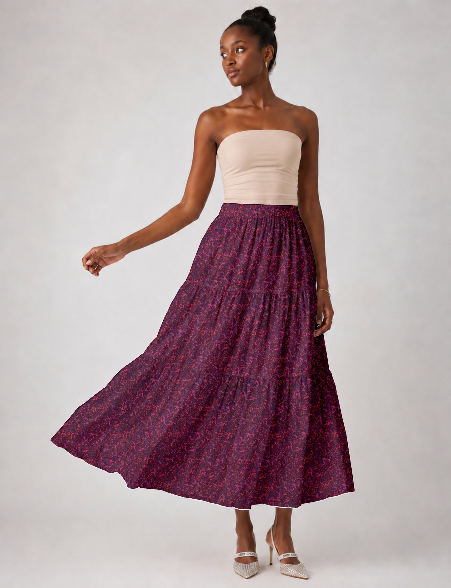 Midi tiered skirt with fitted waistband, soft knife pleats, flared silhouette, side seam pockets, and ankle-length hem