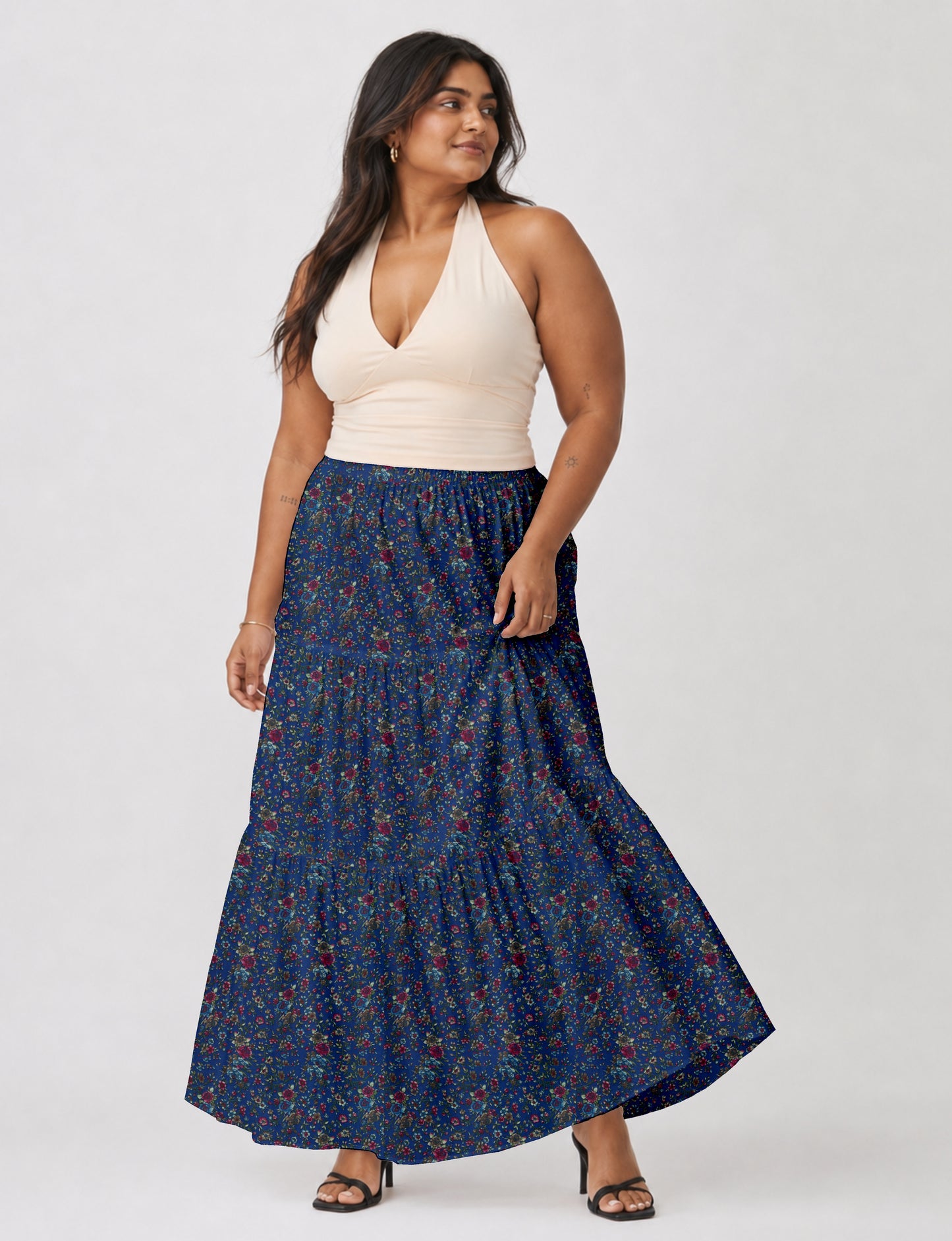 Midi tiered skirt with fitted waistband, soft knife pleats, flared silhouette, side seam pockets, and ankle-length hem