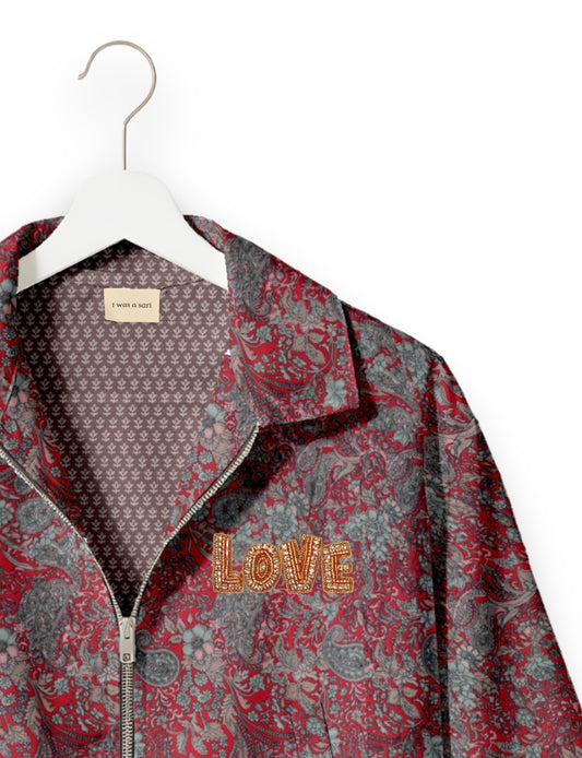 Love Bomber Jacket made from recycled fabric, featuring hand-stitched Aari embroidery. A unique piece of zero-waste clothing, part of the circular fashion movement. Designed with upcycled materials for a stylish yet environmentally friendly clothing choice.