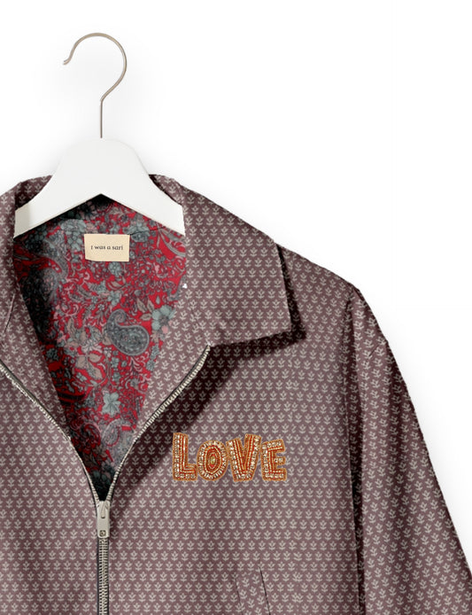Love Bomber Jacket made from recycled fabric, featuring hand-stitched Aari embroidery. A unique piece of zero-waste clothing, part of the circular fashion movement. Designed with upcycled materials for a stylish yet environmentally friendly clothing choice.