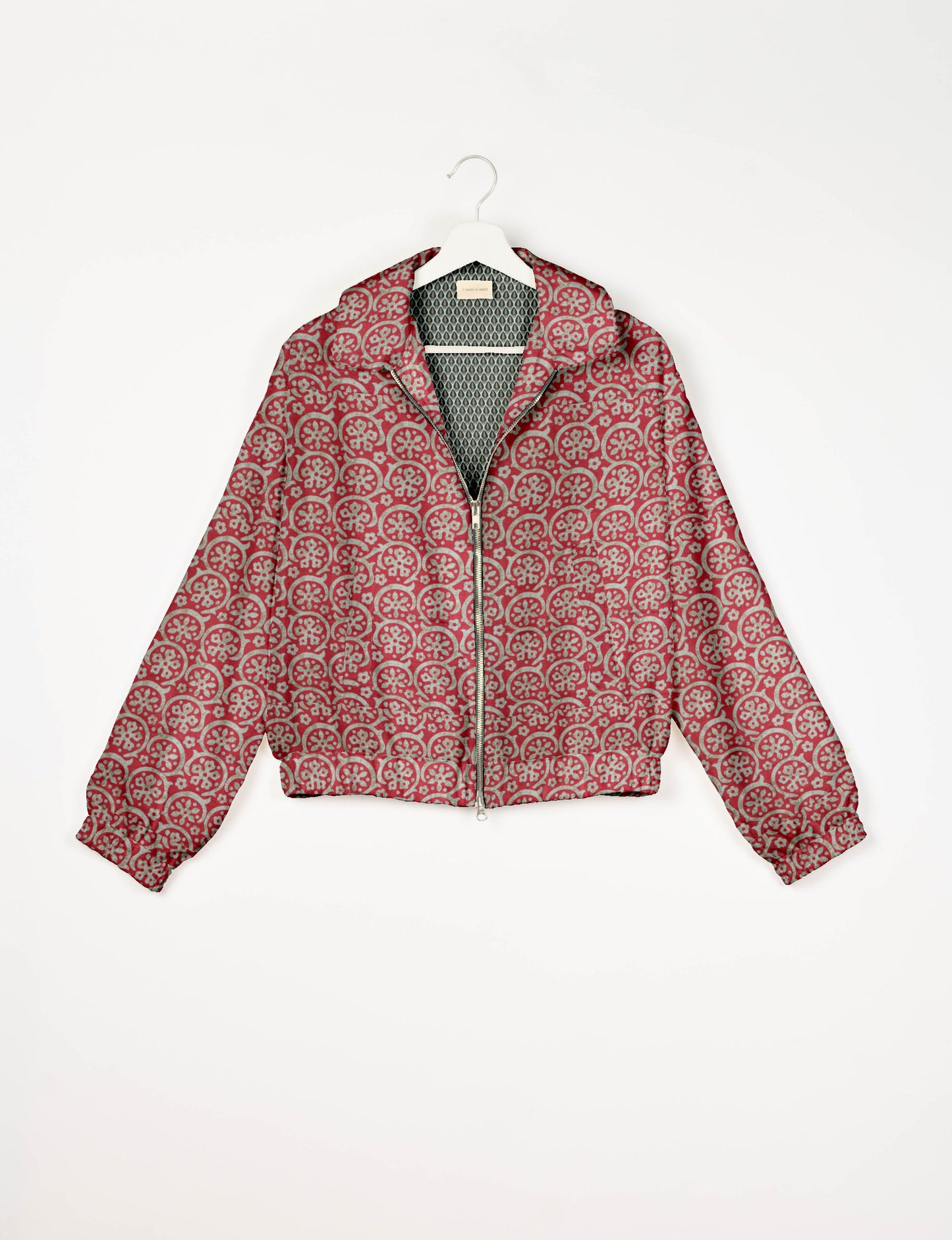 Upcycled Bomber Jacket made from recycled sari materials, featuring a cute cropped shape, elasticated hem and cuffs, and contrast sari print lining. Sustainable apparel promoting eco-friendly fashion and ethical clothing.