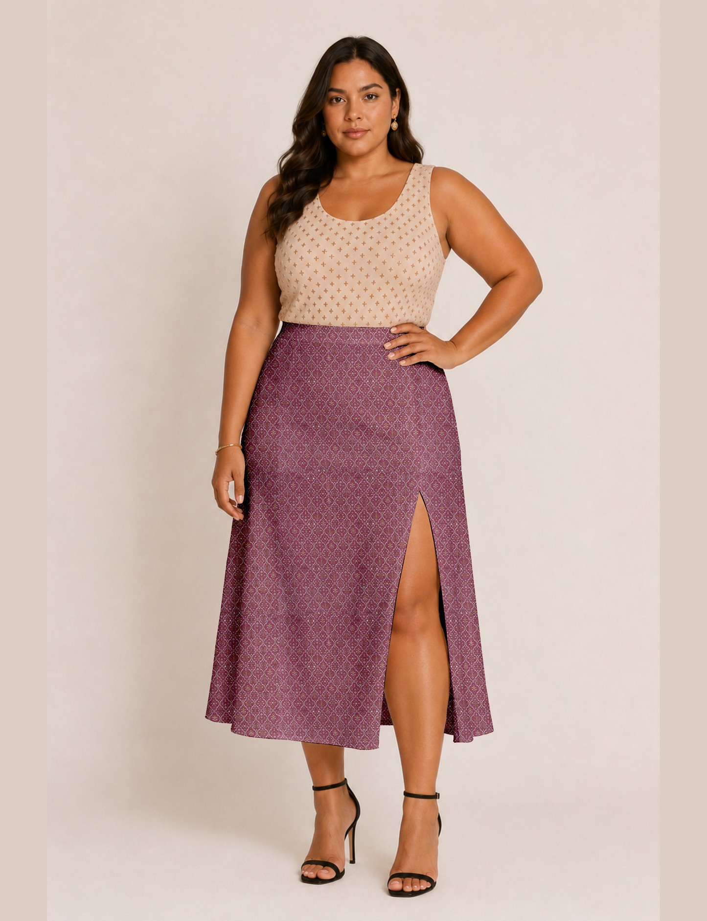 Woman wearing a yellow and black micro patterned A-line skirt with front slit, paired with beige sleeveless top and black