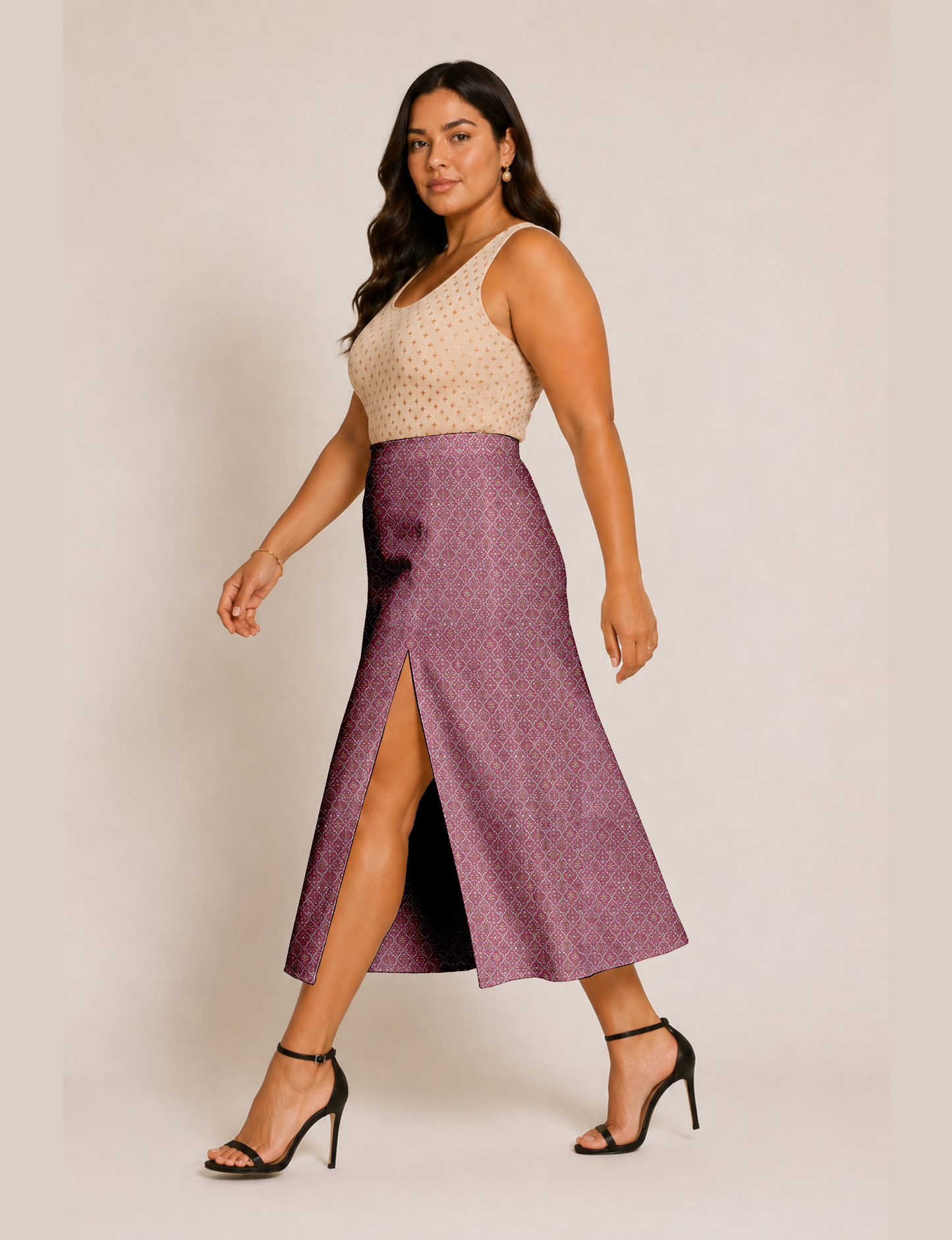 Woman wearing a yellow and black micro patterned A-line skirt with front slit, paired with beige sleeveless top and black