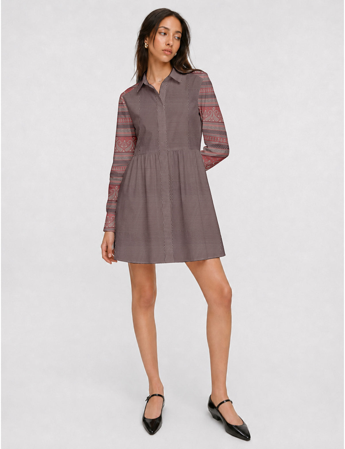 Short shirt dress with a relaxed A-line silhouette, point collar, partial button placket, gathered waist, side pockets, and full-length cuffed sleeves.