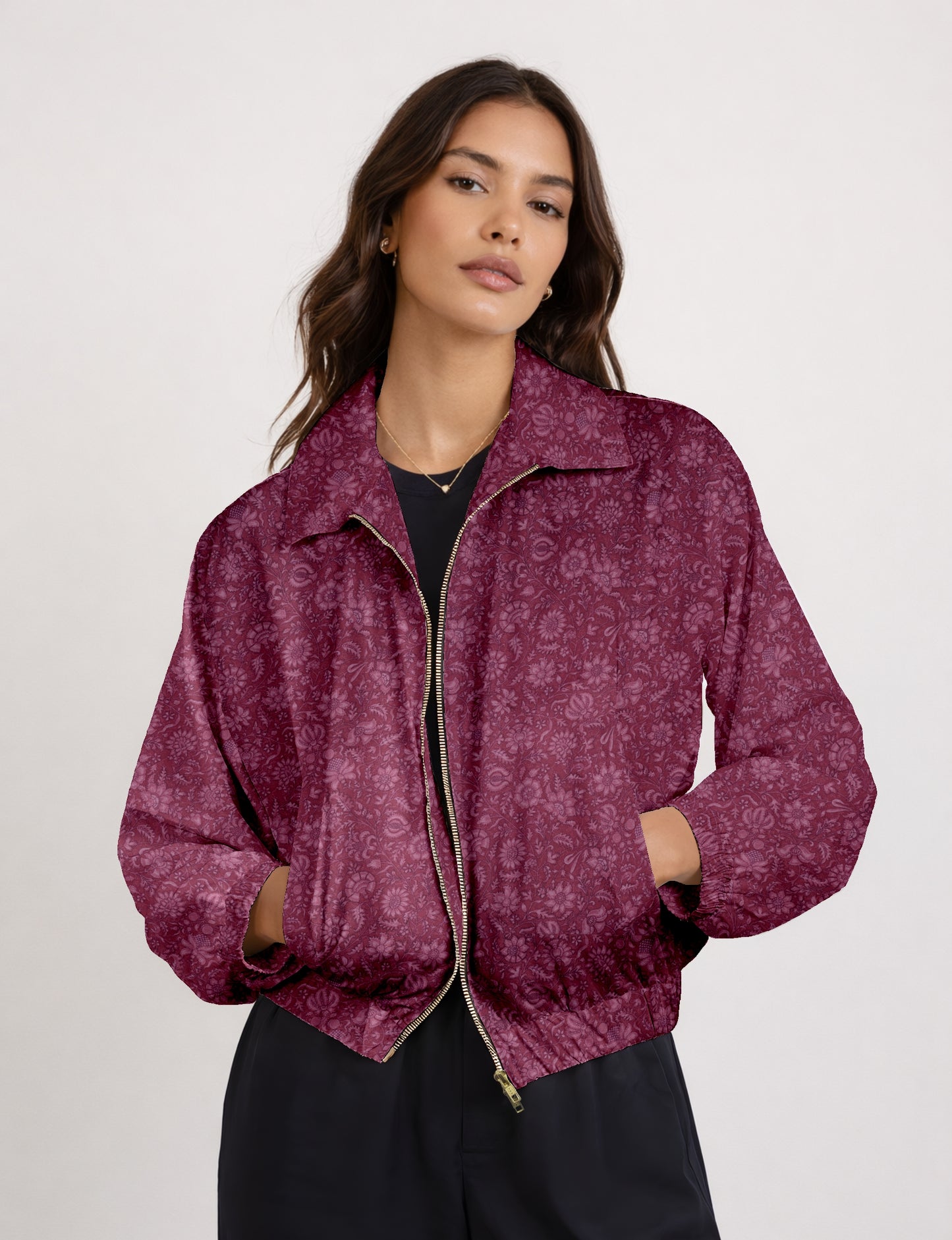 Women's cropped bomber jacket with twin metallic front zippers, welt pockets, elasticated hem and cuffs, and contrast sari print lining.