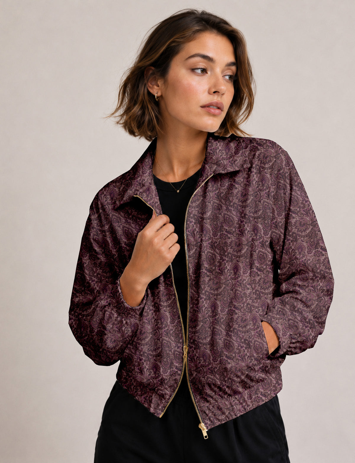 Woman wearing a yellow floral bomber jacket with front zipper, elastic cuffs, and side pockets, shown from front view