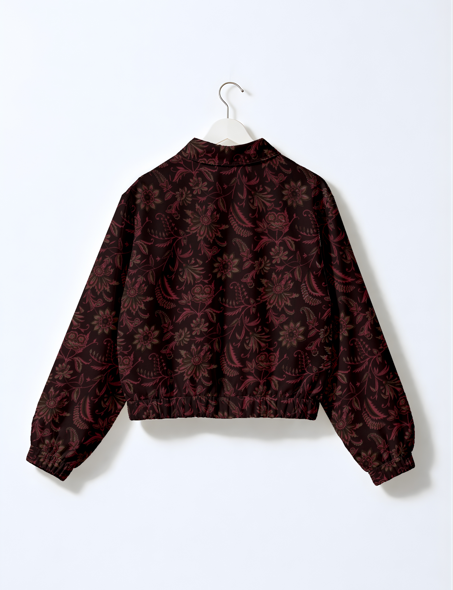 Women's cropped bomber jacket with twin metallic front zippers, welt pockets, elasticated hem and cuffs, and contrast sari print lining.