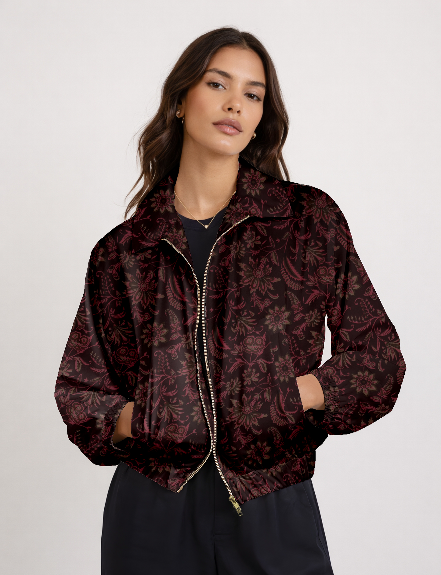 Women's cropped bomber jacket with twin metallic front zippers, welt pockets, elasticated hem and cuffs, and contrast sari print lining.