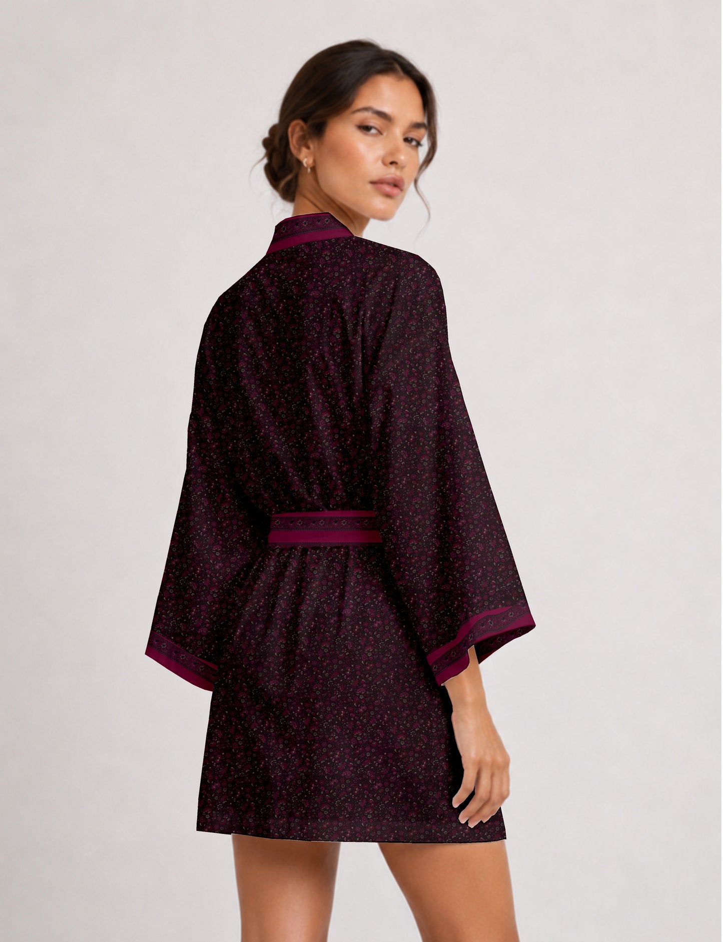 Short kimono robe with wrap front, V-neckline, wide sleeves, waist tie, and concealed skort detail.