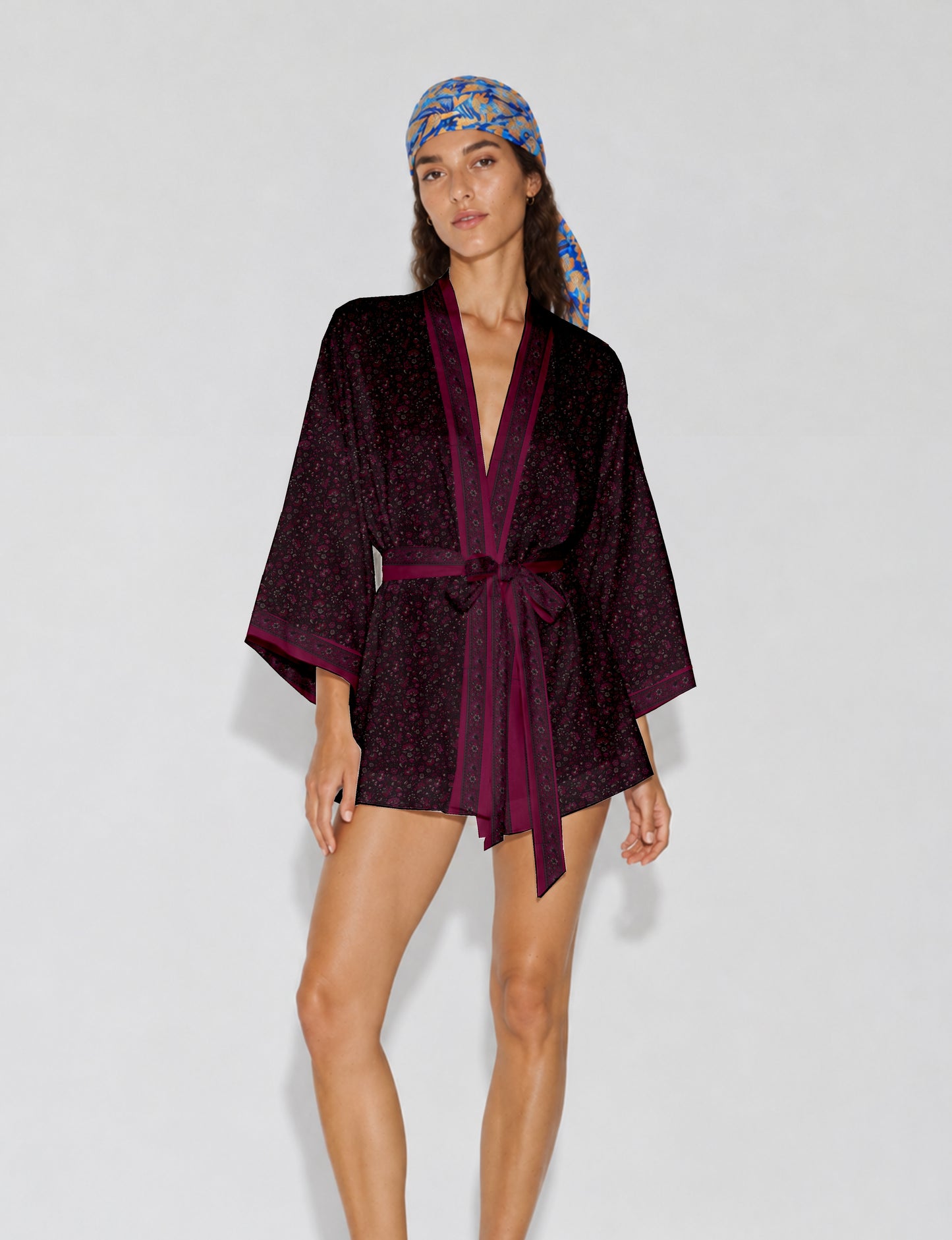 Short kimono robe with wrap front, V-neckline, wide sleeves, waist tie, and concealed skort detail.