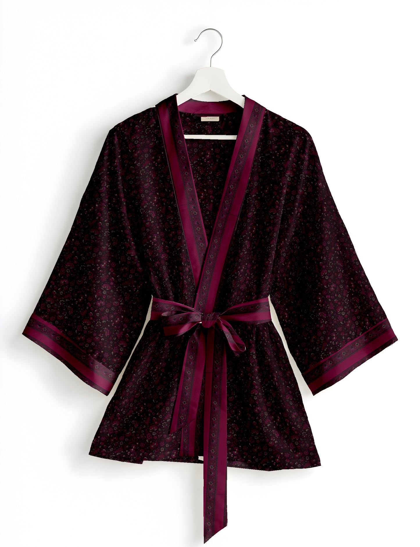 Short kimono robe with wrap front, V-neckline, wide sleeves, waist tie, and concealed skort detail.