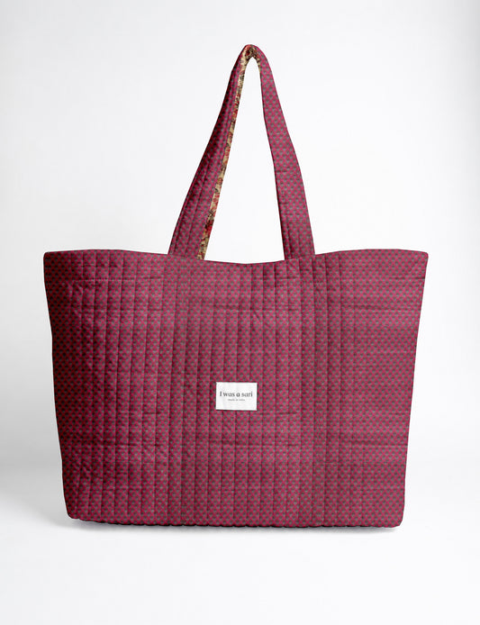 Quilted yellow tropical patterned beach bag with long handles and white label reading "I was a sari" front view