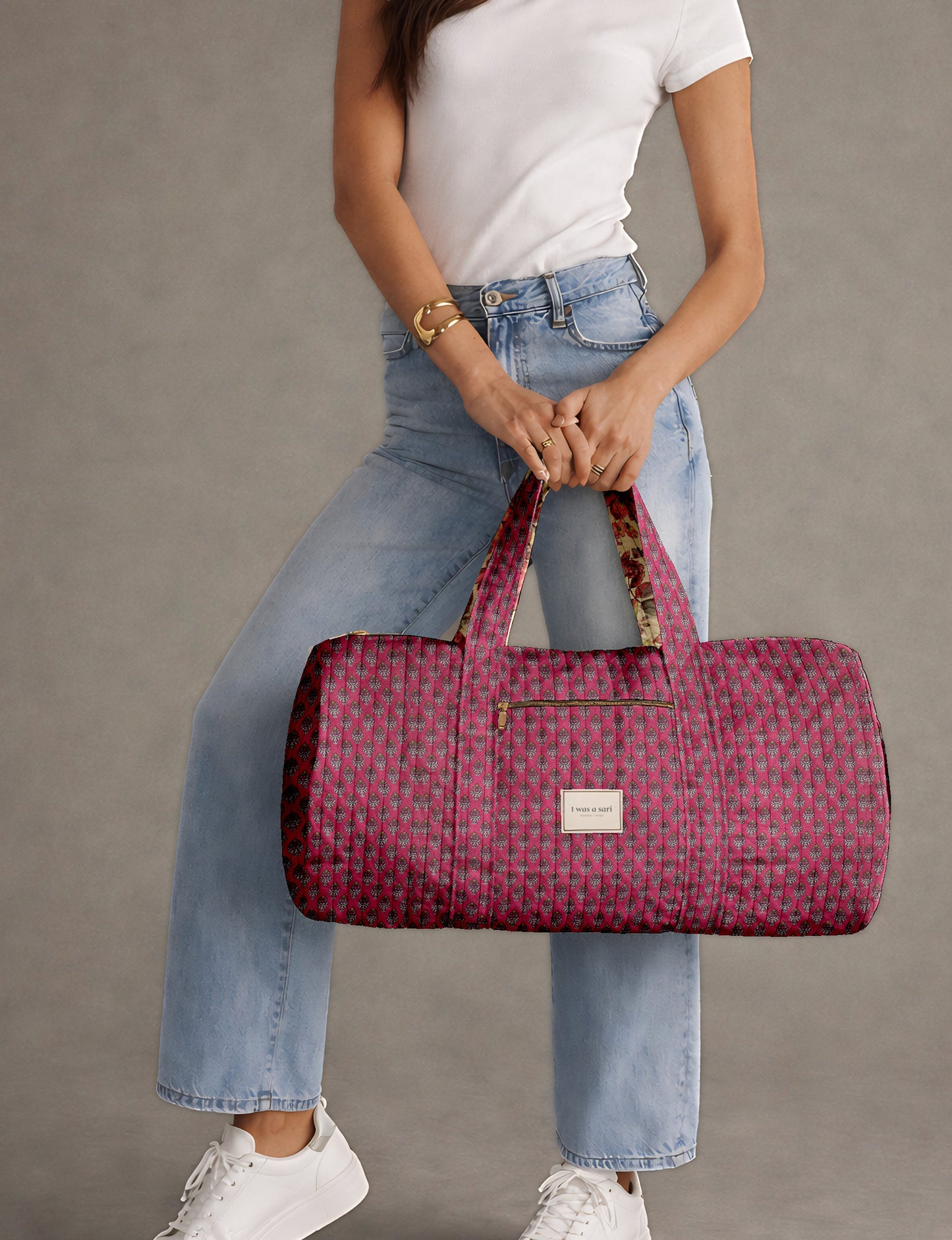 Brown paisley quilted bowling bag with dual handles, front zipper pocket, and "I was a sari" label on front side