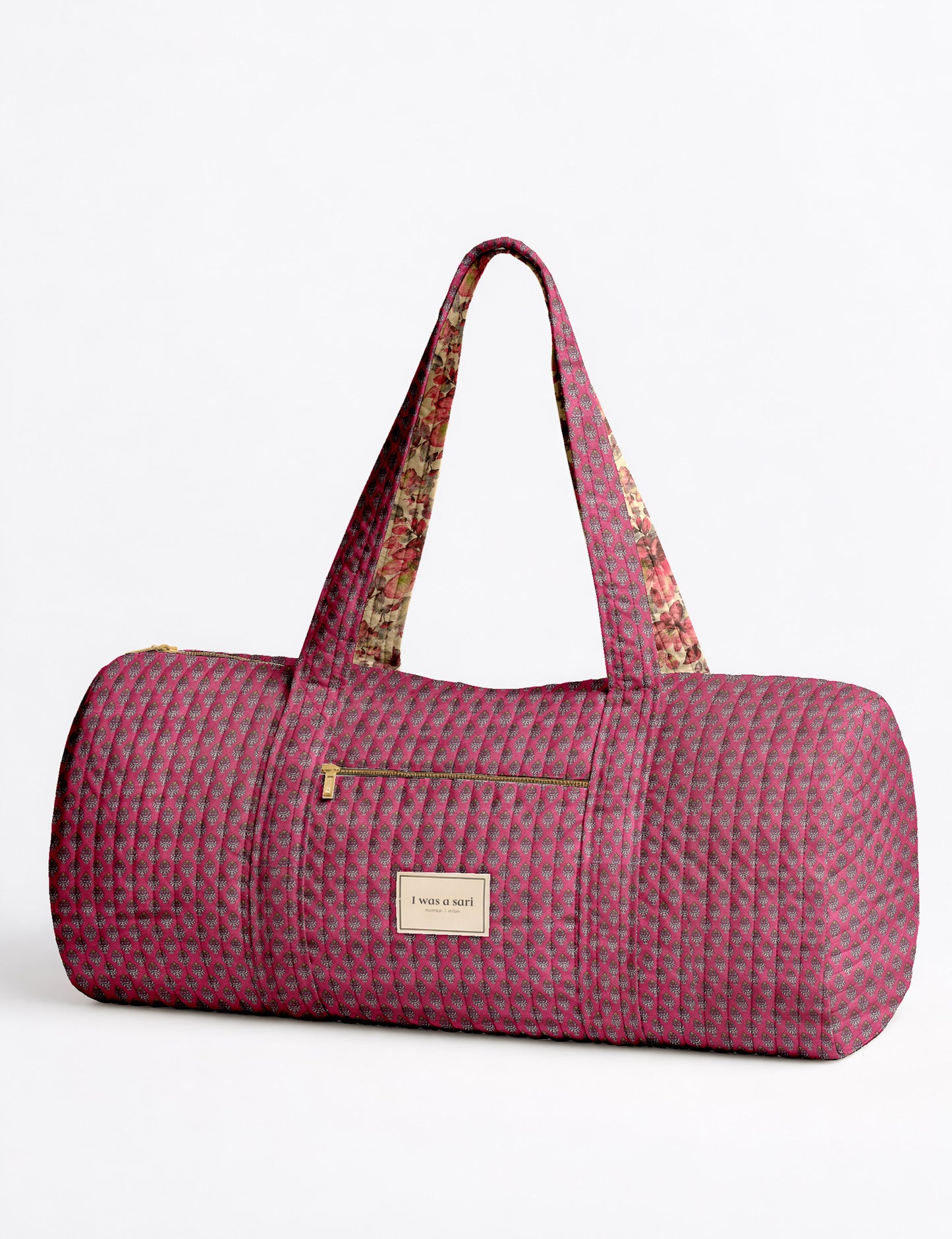 Quilted brown paisley bowling bag with gold zipper, floral interior lining, and interior key clip with label inside pocket
