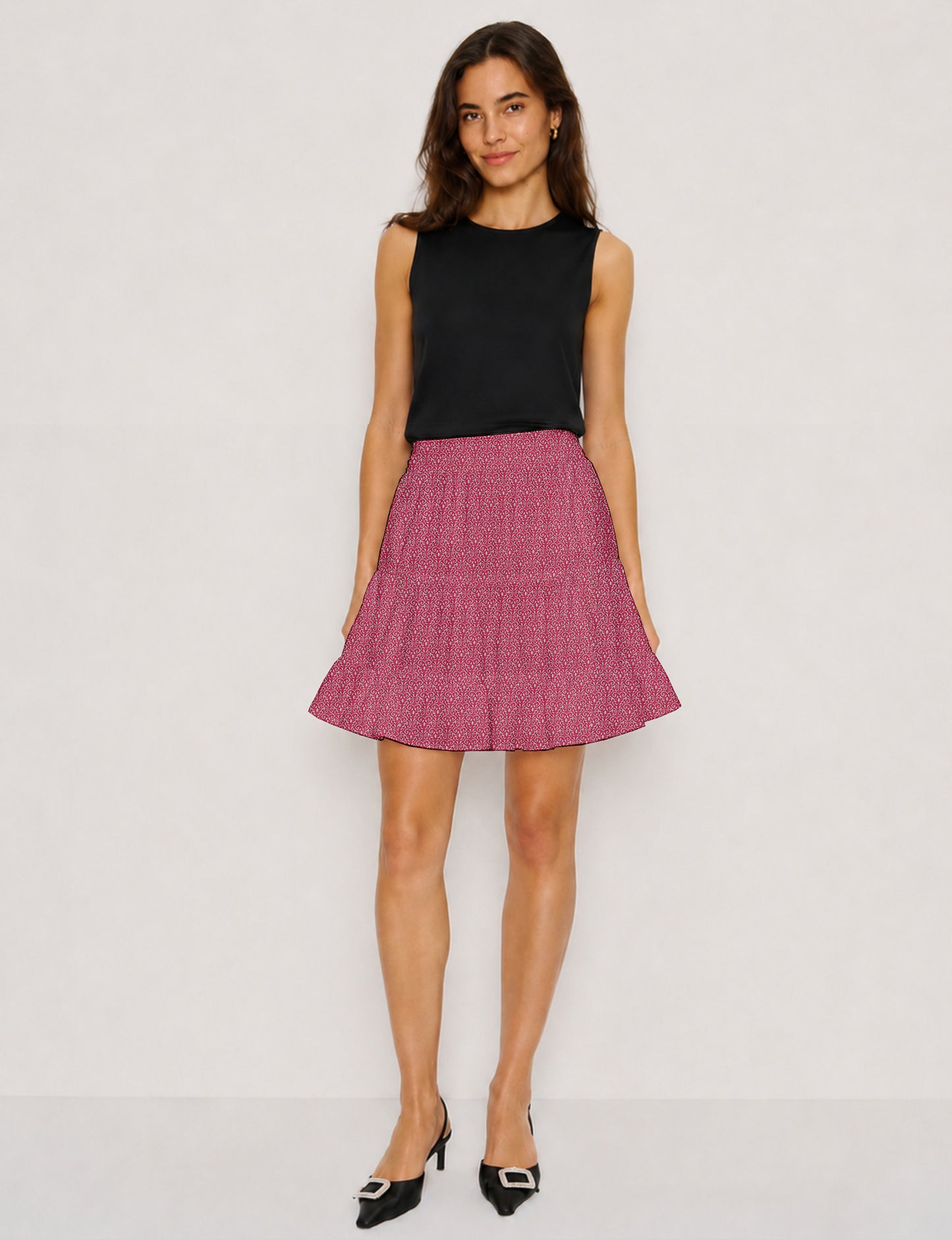 Short tiered skirt with a fitted waistband, knife pleats, softly flared silhouette, side seam pockets, and above-the-knee length.