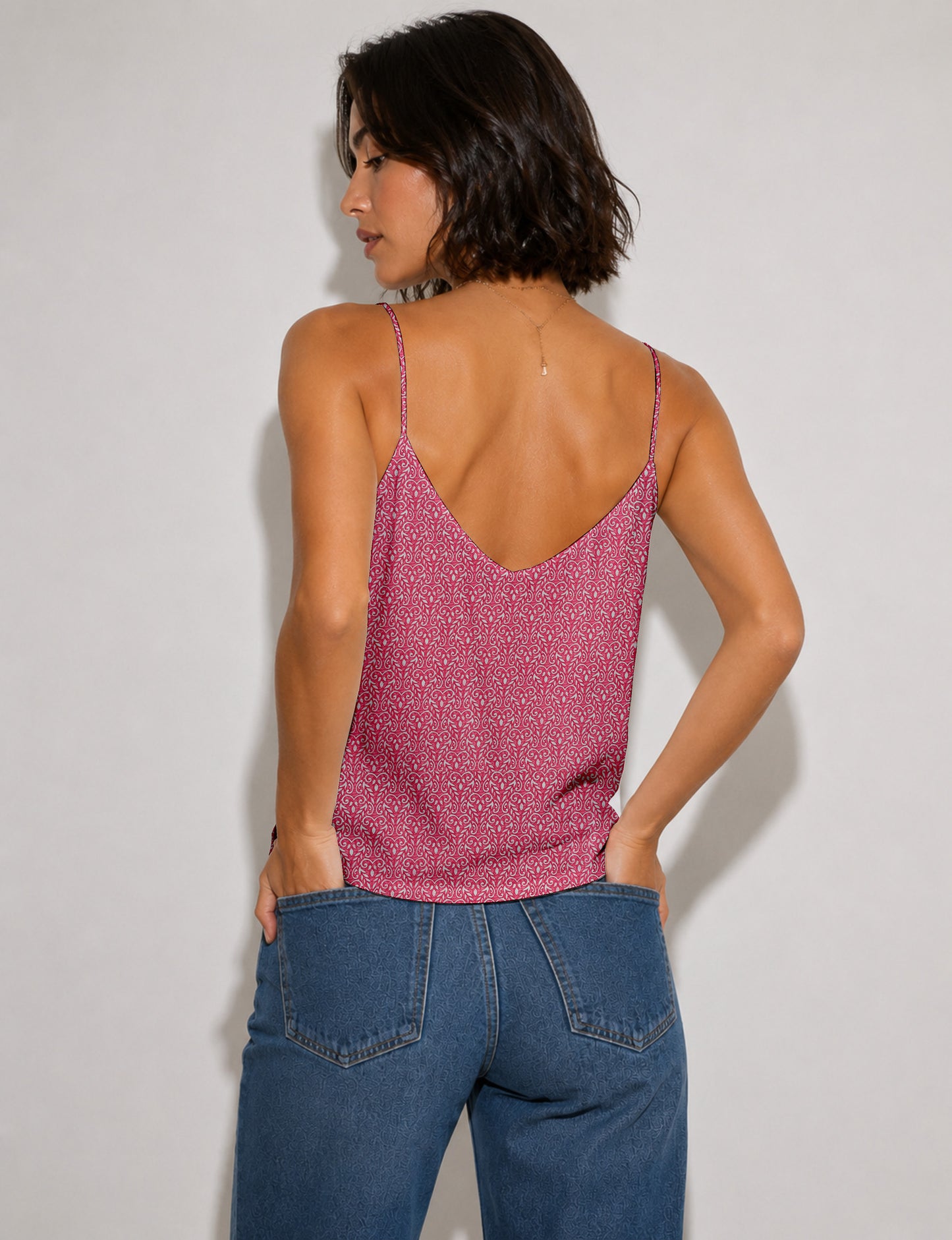 Women's sleeveless slip top with a relaxed straight fit, soft V-neckline, deep V-back, and delicate spaghetti straps.