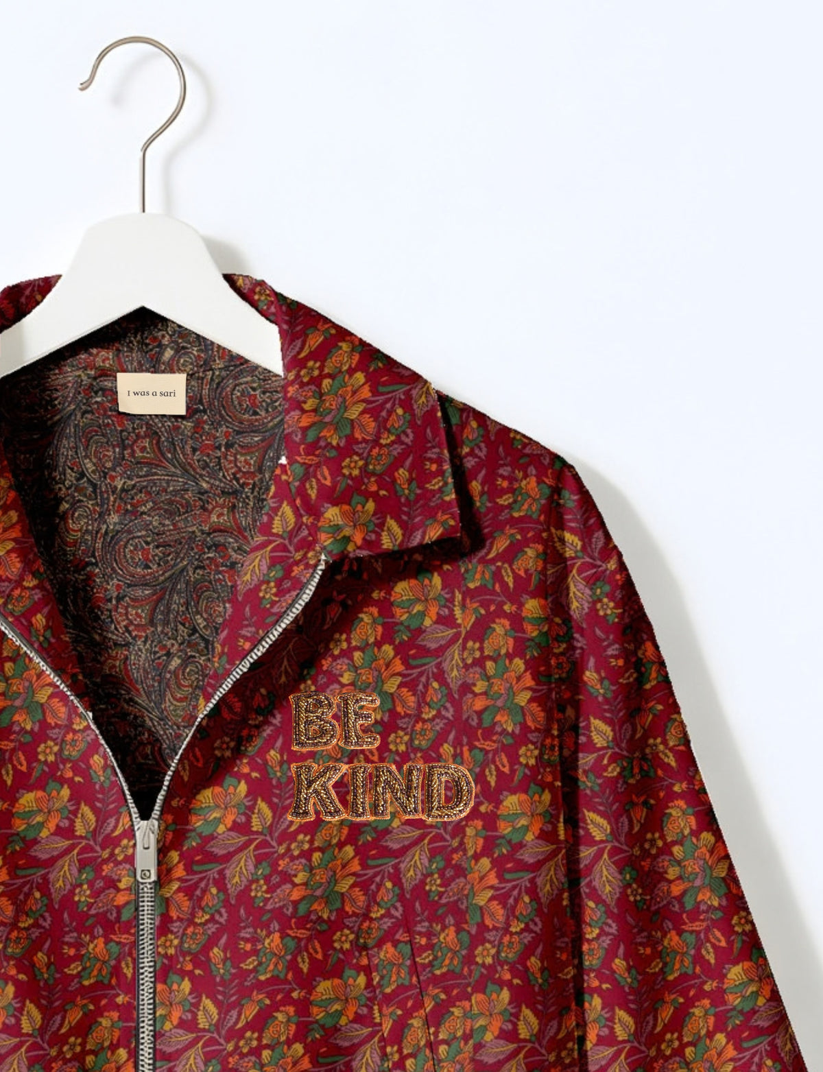 BE KIND Bomber jacket made from upcycled sari fabric with handcrafted Aari embroidery by female artisans.