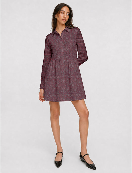 Short shirt dress with a relaxed A-line silhouette, point collar, partial button placket, gathered waist, side pockets, and full-length cuffed sleeves.