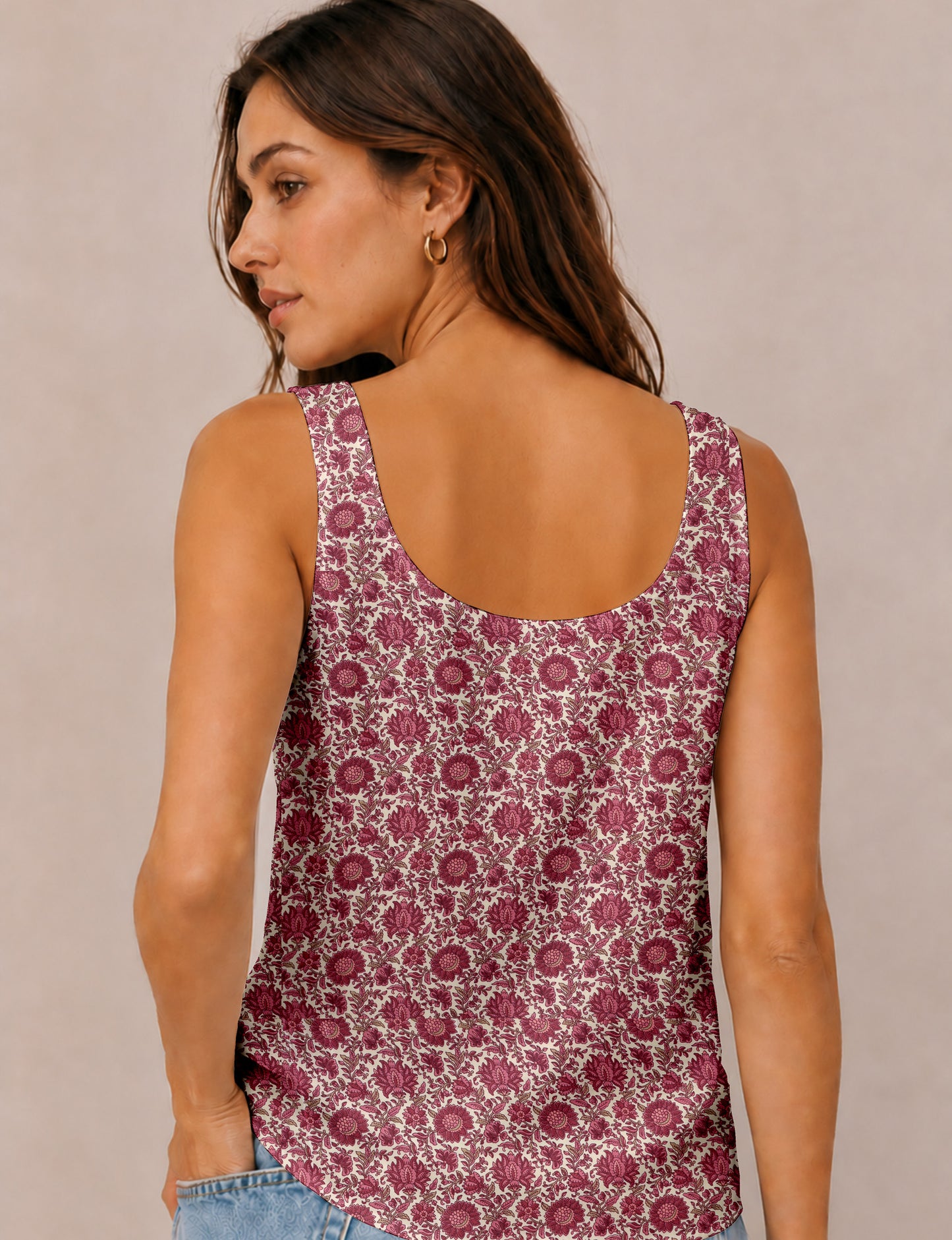 Women's sleeveless blouse with a relaxed straight fit, wide scoop neckline, deep scoop back, and hip-length silhouette.