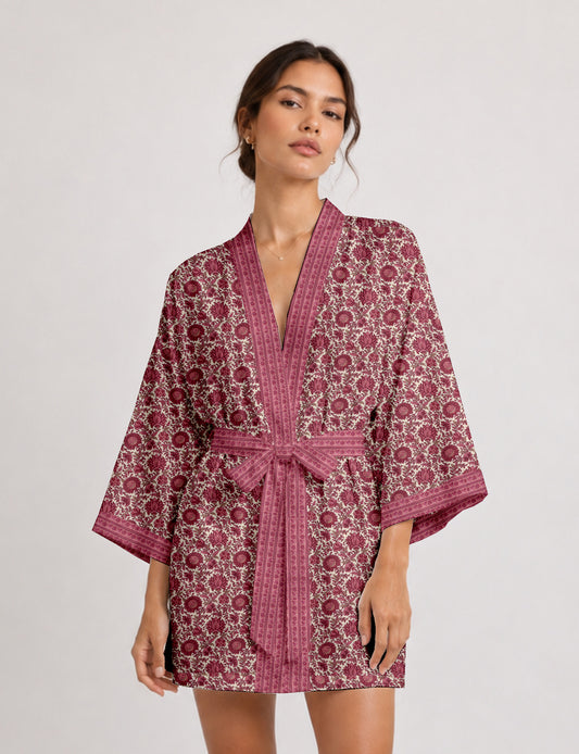 Short kimono robe with wrap front, V-neckline, wide sleeves, waist tie, and concealed skort detail.