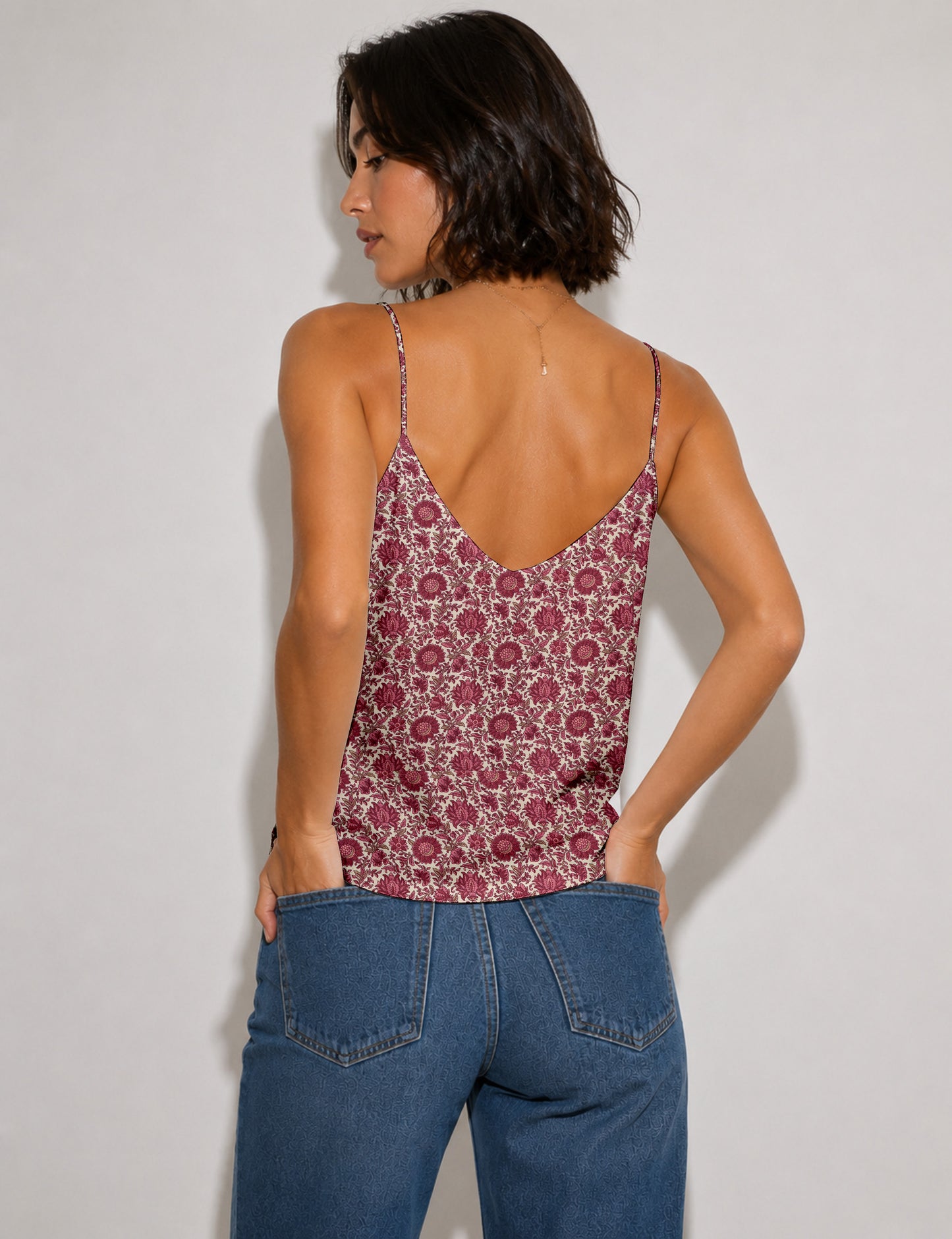 Women's sleeveless slip top with a relaxed straight fit, soft V-neckline, deep V-back, and delicate spaghetti straps.