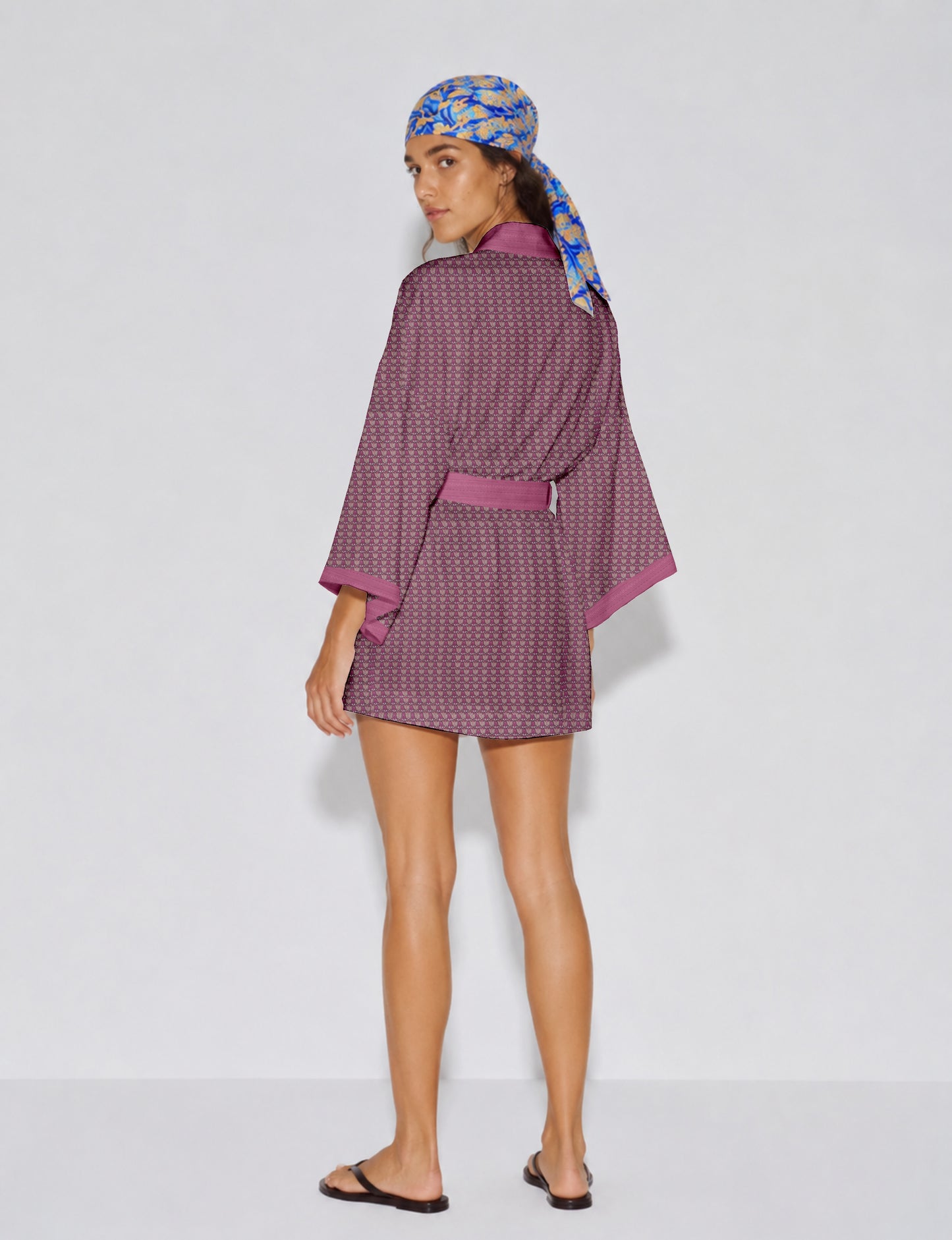 Short kimono robe with wrap front, V-neckline, wide sleeves, waist tie, and concealed skort detail.