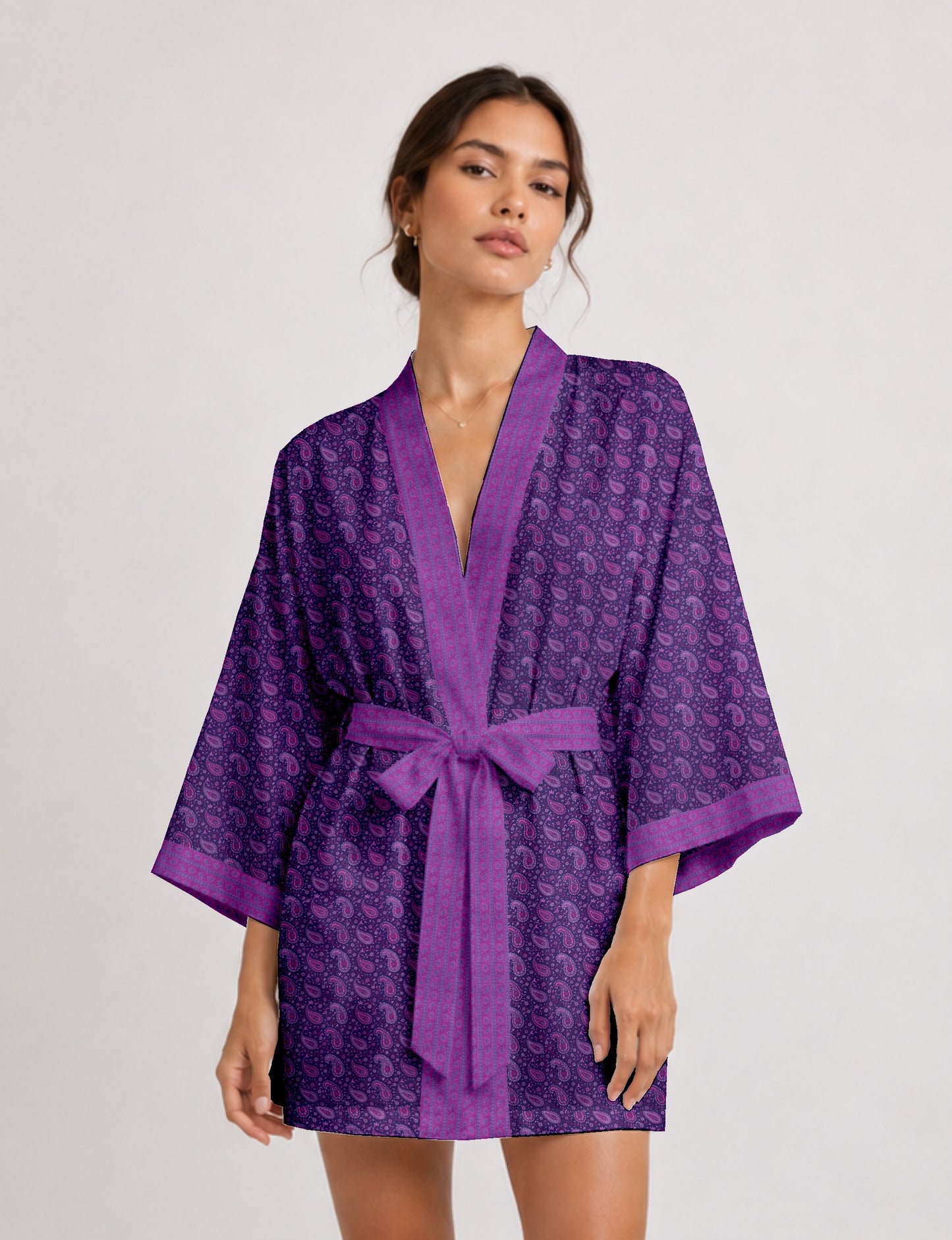 Short kimono robe with wrap front, V-neckline, wide sleeves, waist tie, and concealed skort detail.