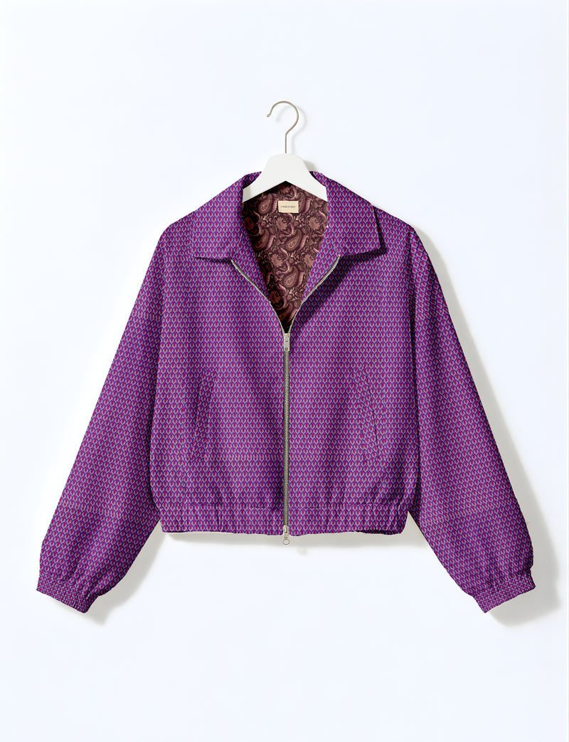 Purple floral bomber jacket with front zipper and elastic cuffs, shown on a white hanger against a white background