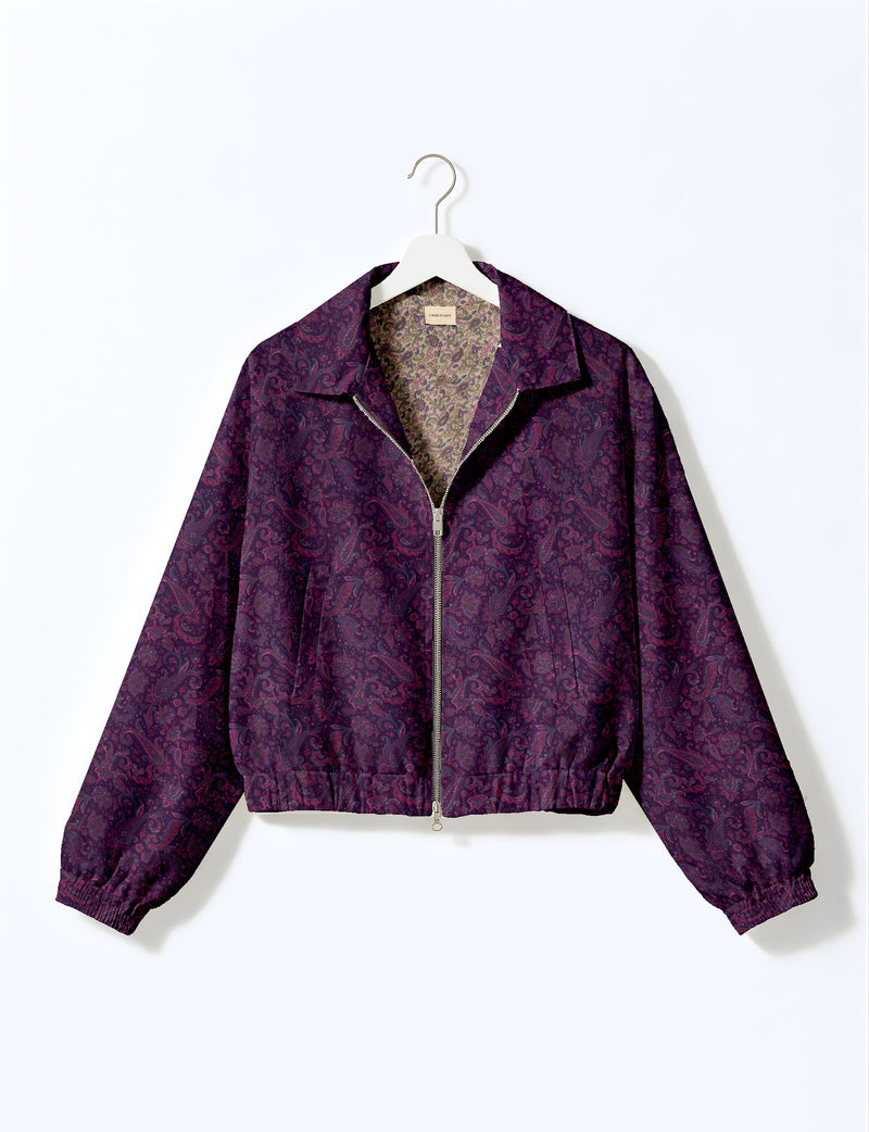 Woman wearing a yellow floral bomber jacket with front zipper, elastic cuffs, and side pockets, shown from front view
