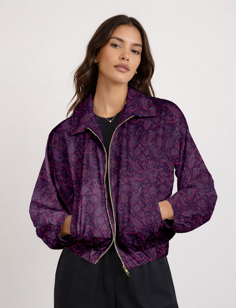 Brown floral bomber jacket with front zipper, elastic cuffs and hem, hanging on white hanger, red floral inner lining visible
